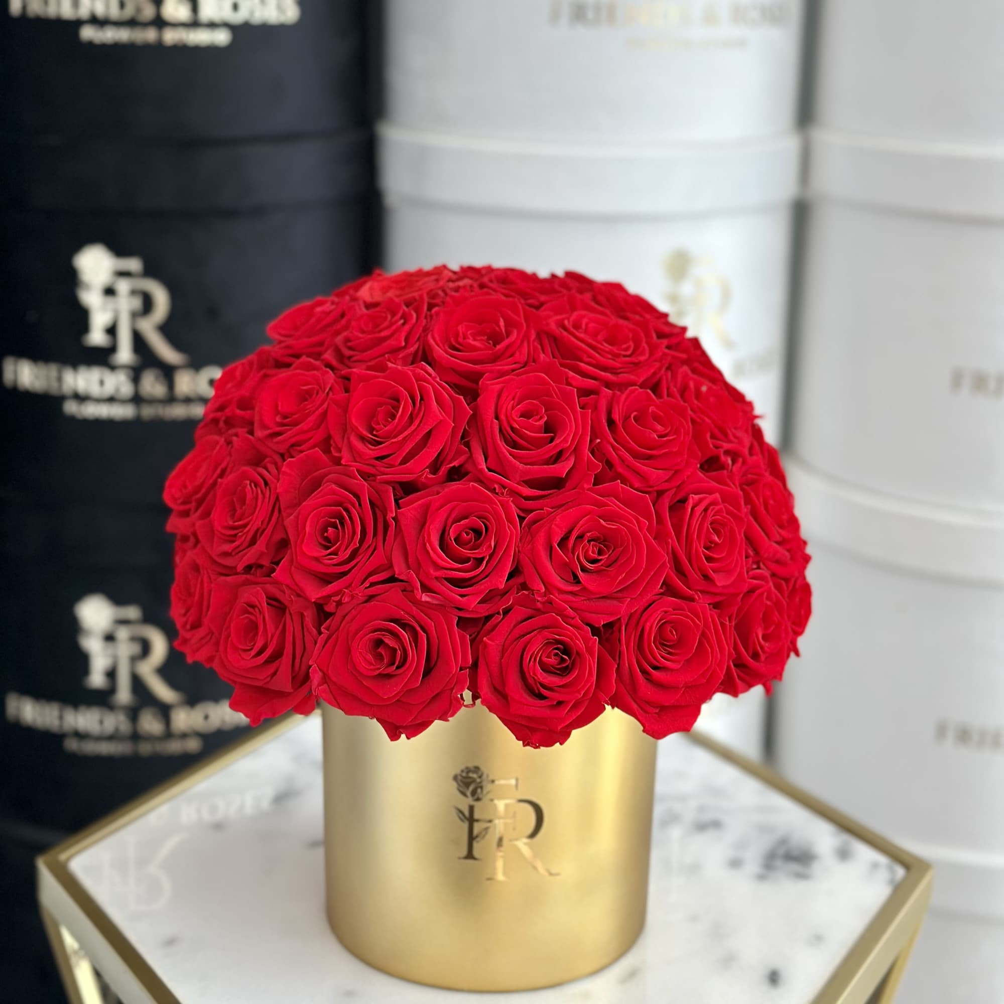 Red roses arranged in a gold cylindrical box, photo 3 of 3