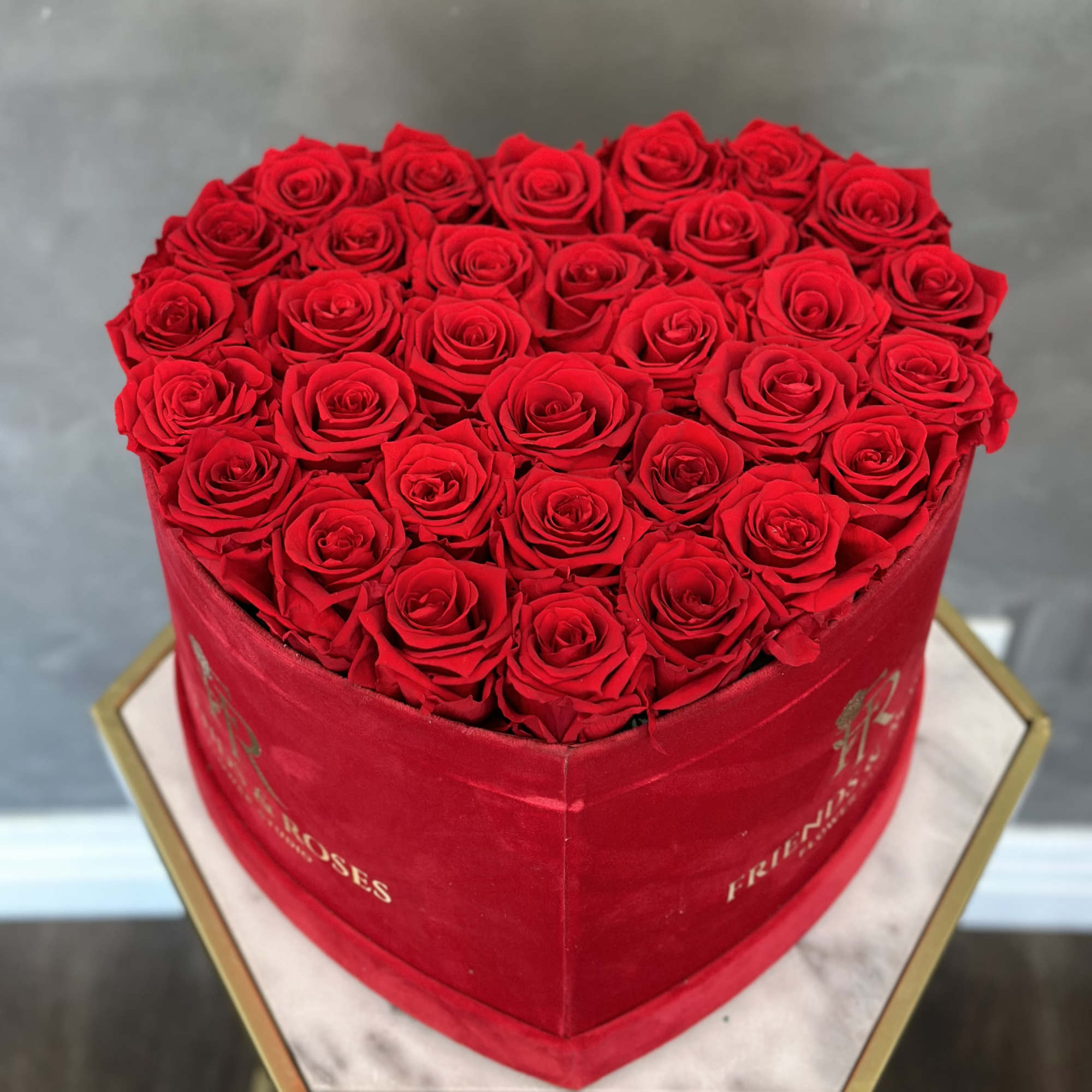 Heart-shaped box filled with red roses