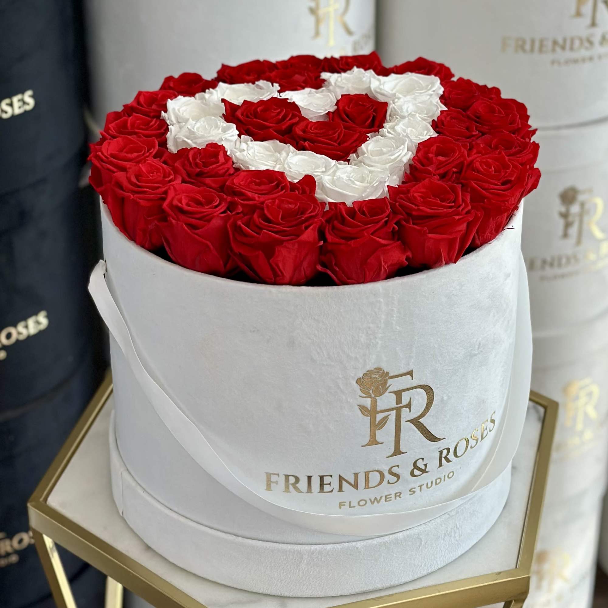 Round box of red and white roses arranged in a heart pattern