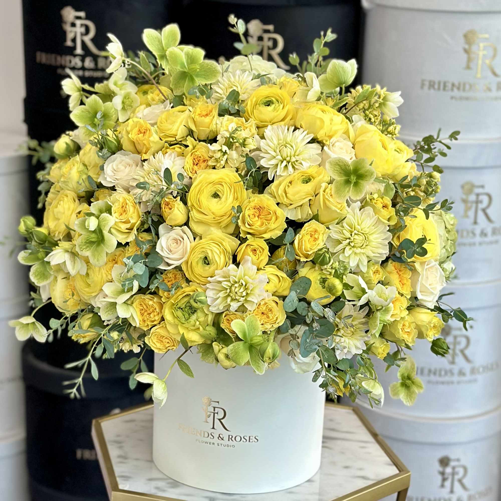Yellow and white flower arrangement in a white hat box, photo 2 of 3