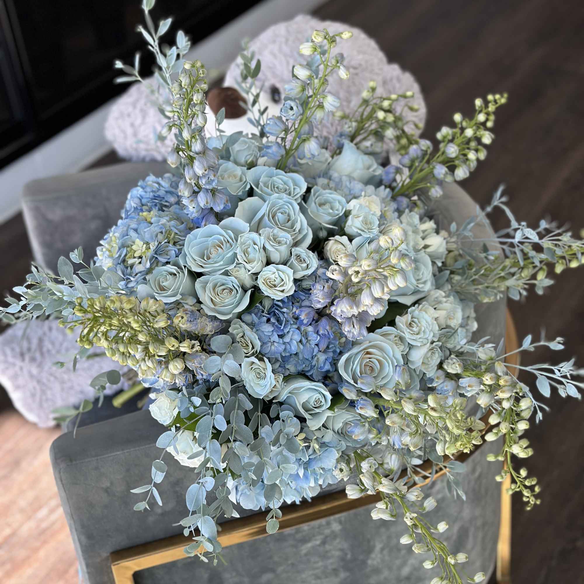 Blue roses and hydrangeas arranged with airy filler in a bouquet