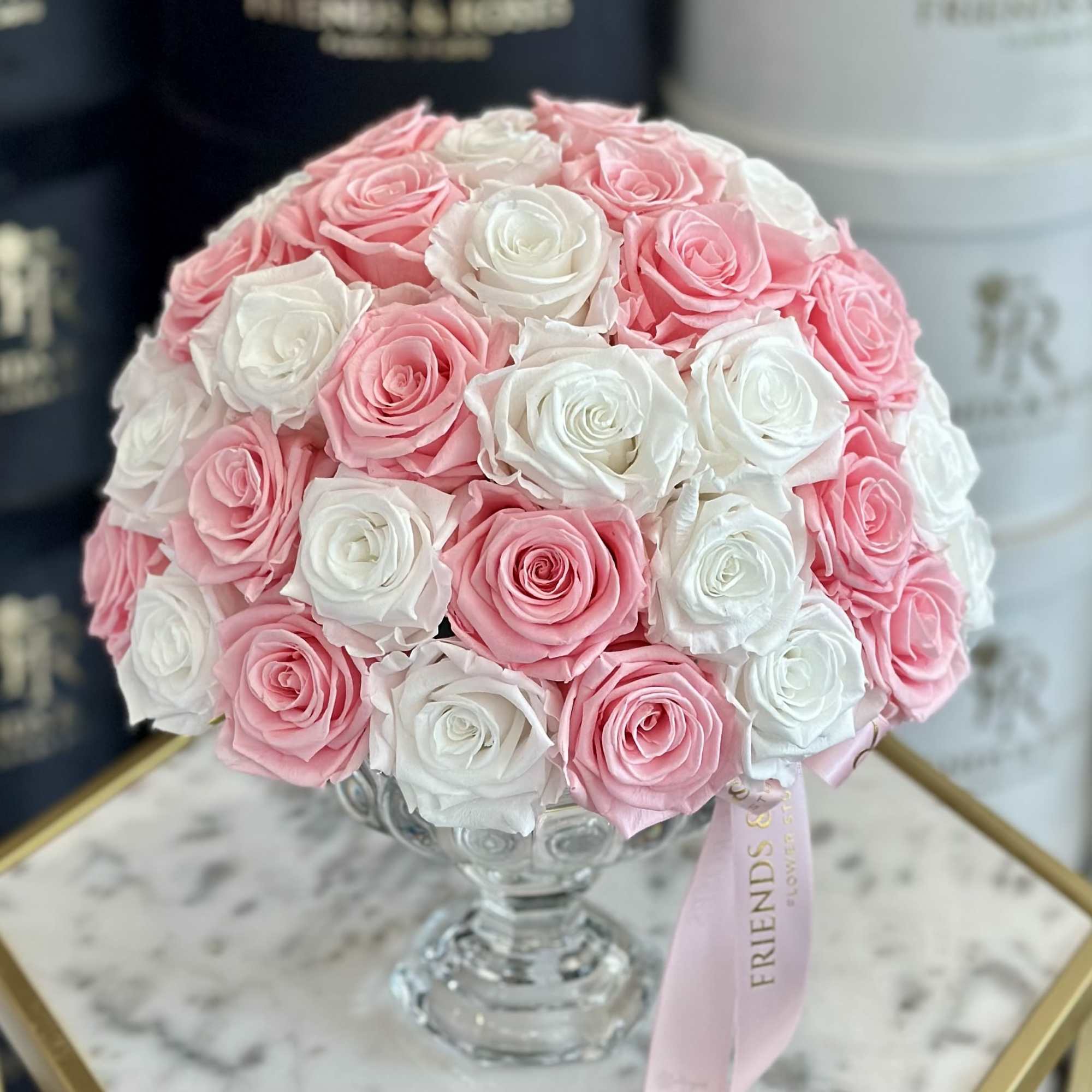 Pink and white rose bouquet in a clear glass vase