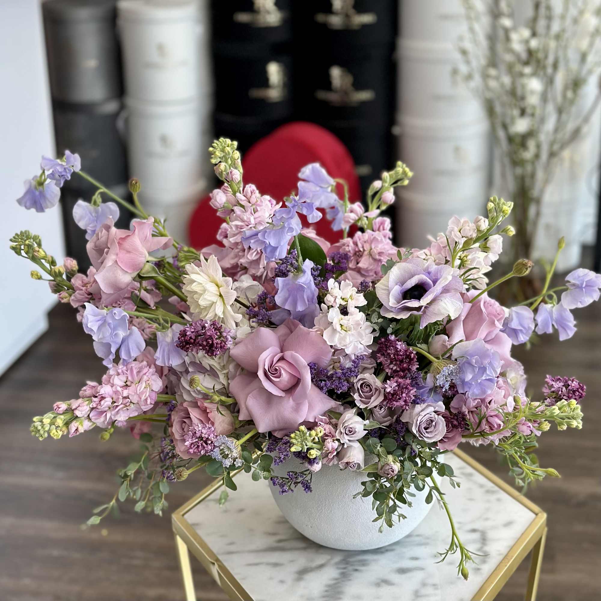 Lavender and pink floral arrangement in a white vase