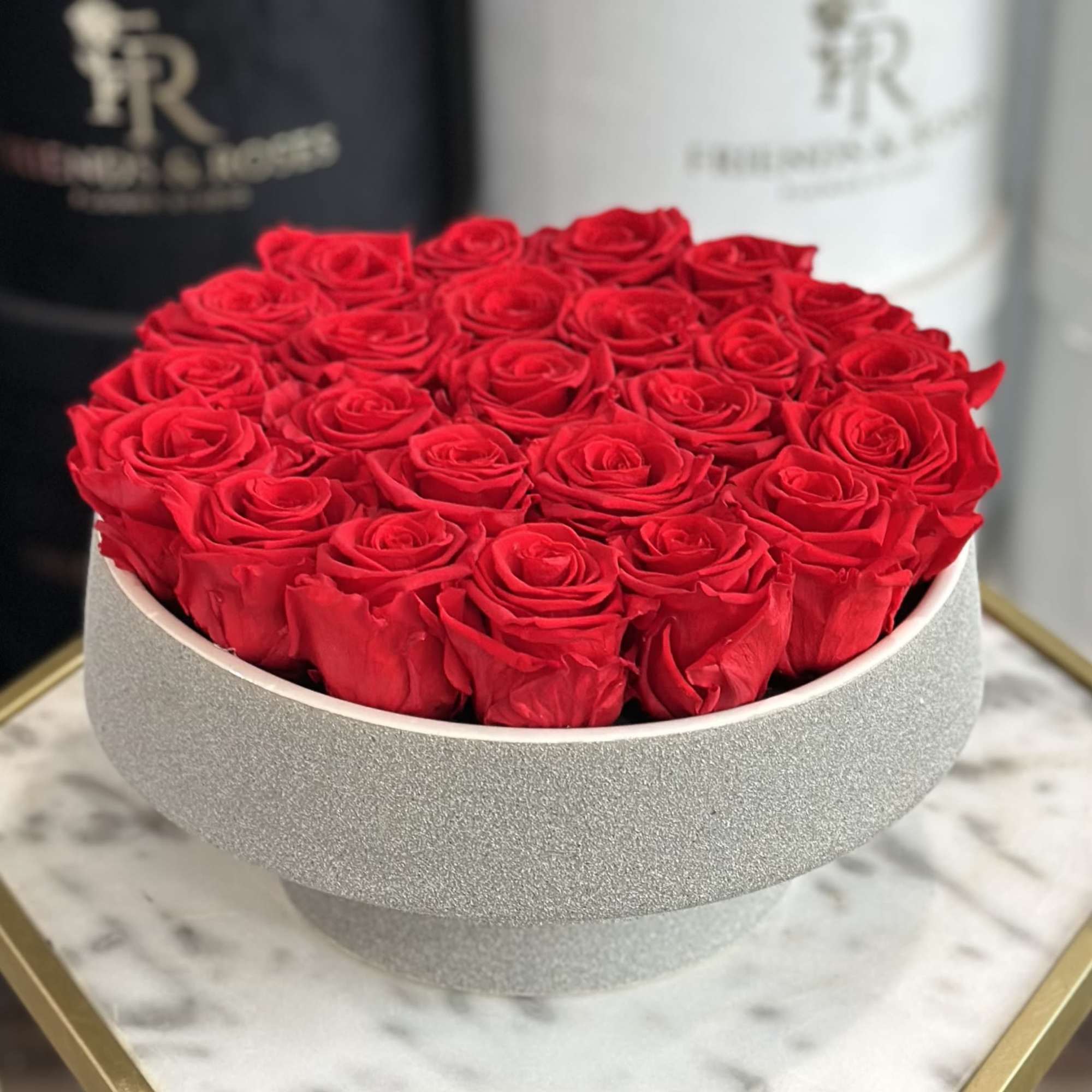 Round box filled with red roses
