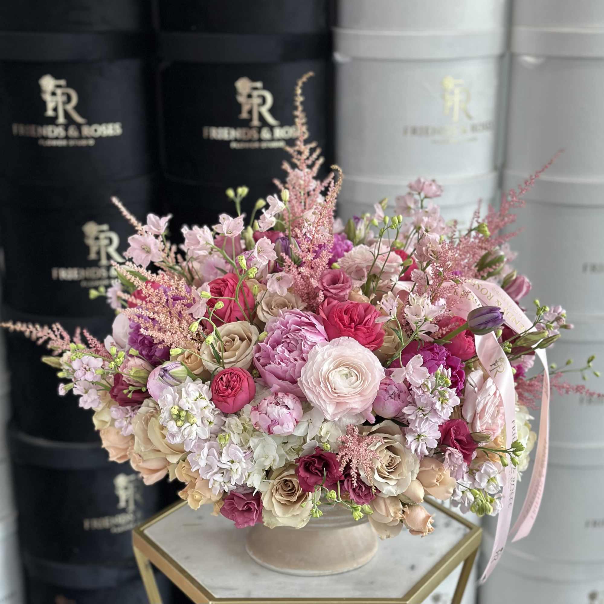 Pink and cream bouquet in a round vase with ribbon