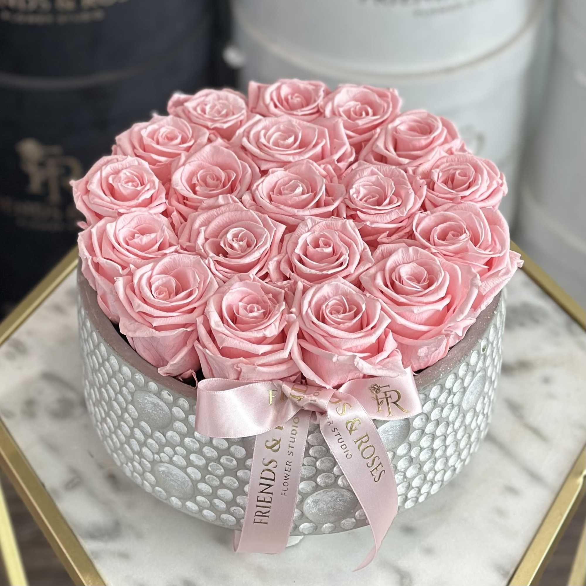 Pink roses arranged in a round silver box with a pink ribbon, photo 2 of 3
