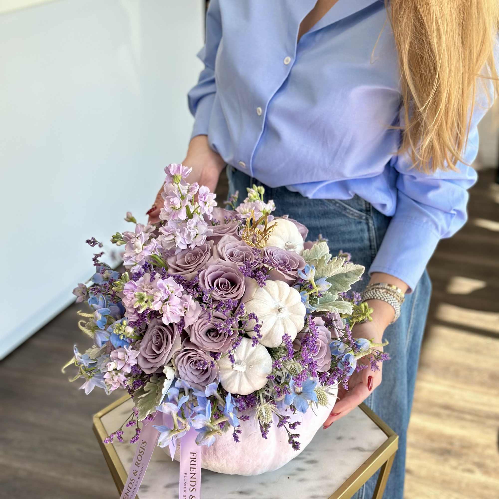 Lavender rose bouquet with white pumpkins in a pink vase