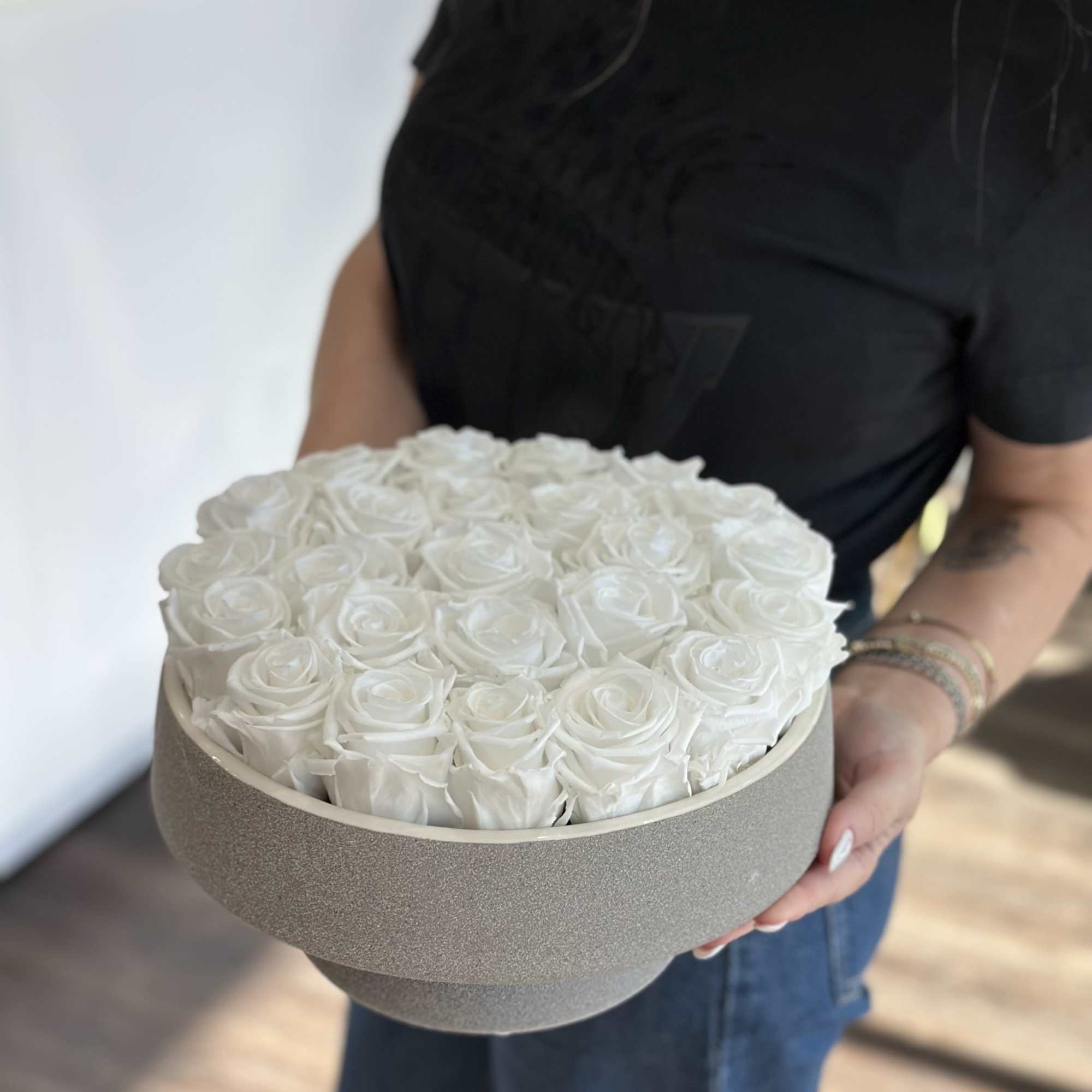 Round box filled with white roses