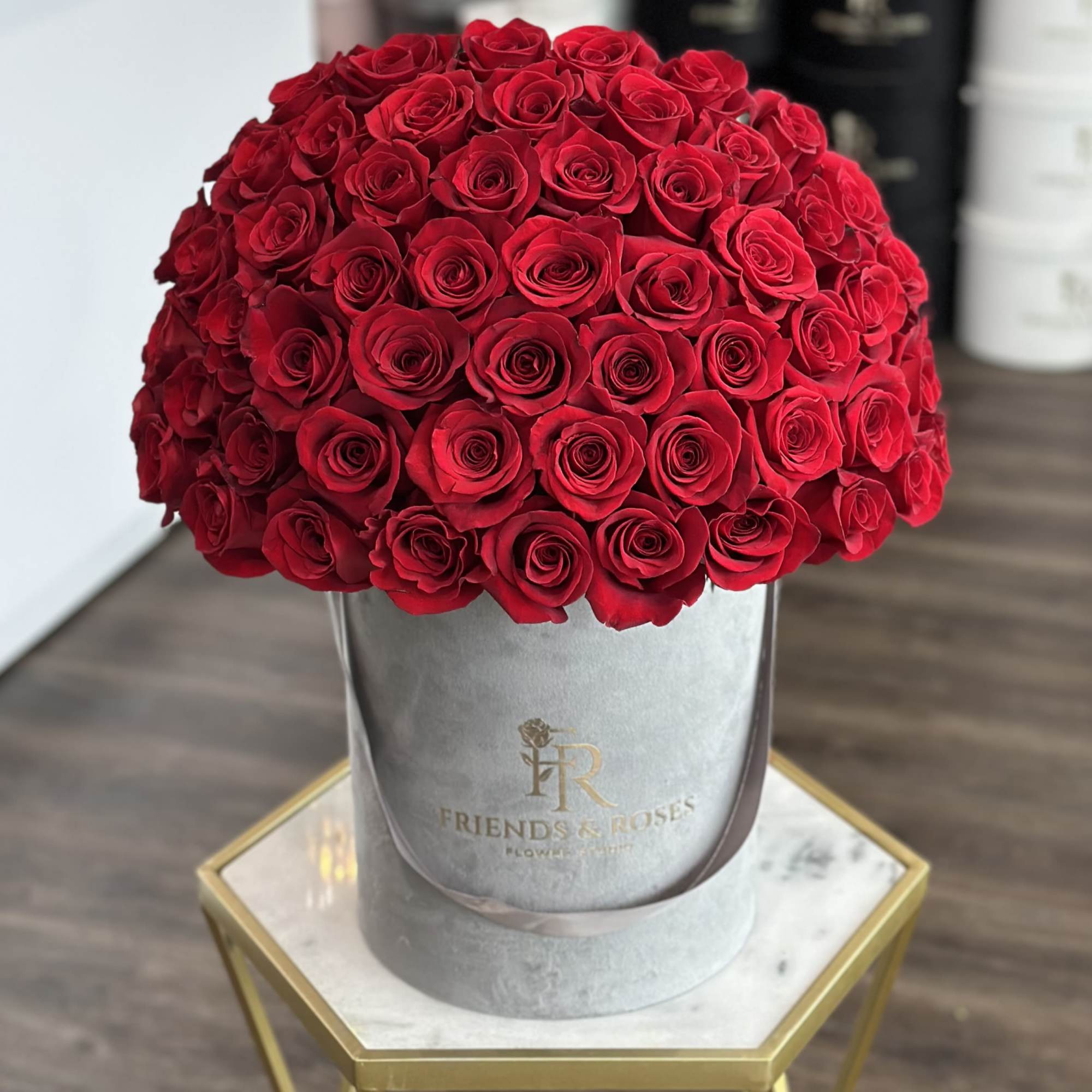 Large dome of red roses in a gray hatbox