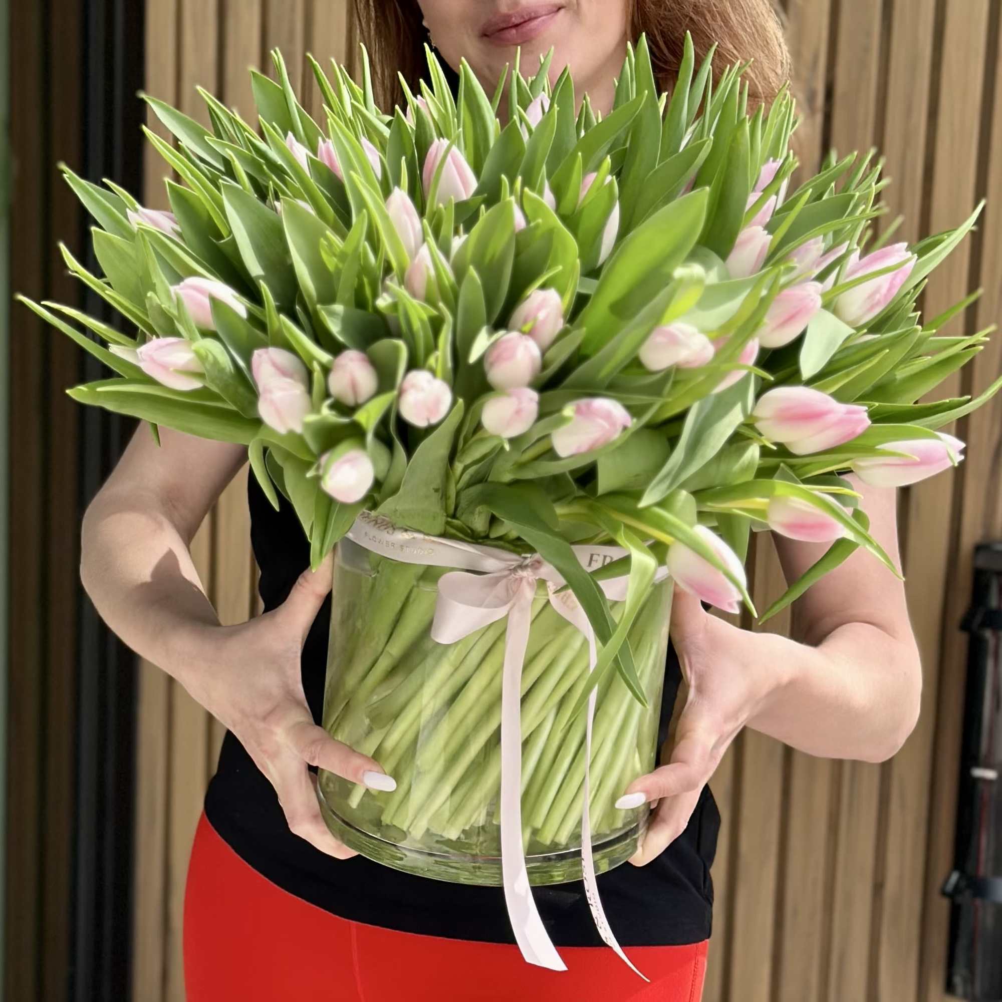A breathtaking arrangement of 100 premium blush pink tulips designed in a