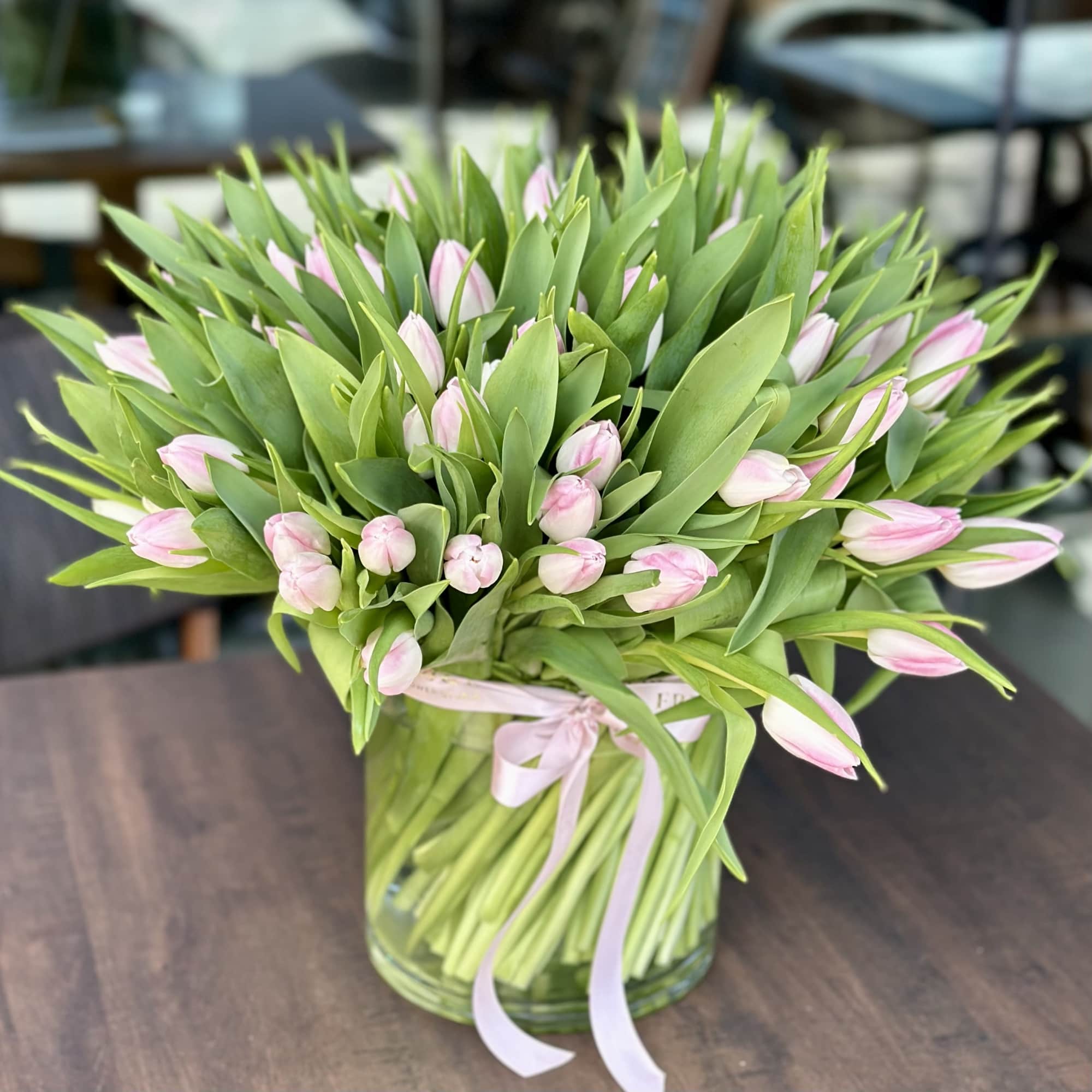 A breathtaking arrangement of 100 premium blush pink tulips designed in a, photo 4 of 4