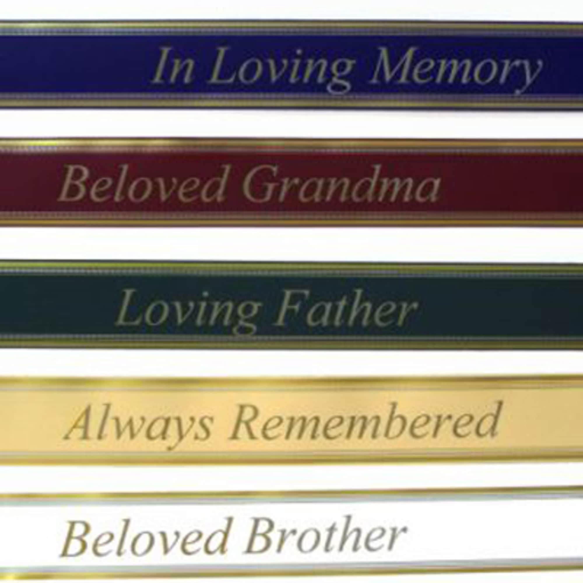 Stack of memorial ribbon banners with remembrance phrases