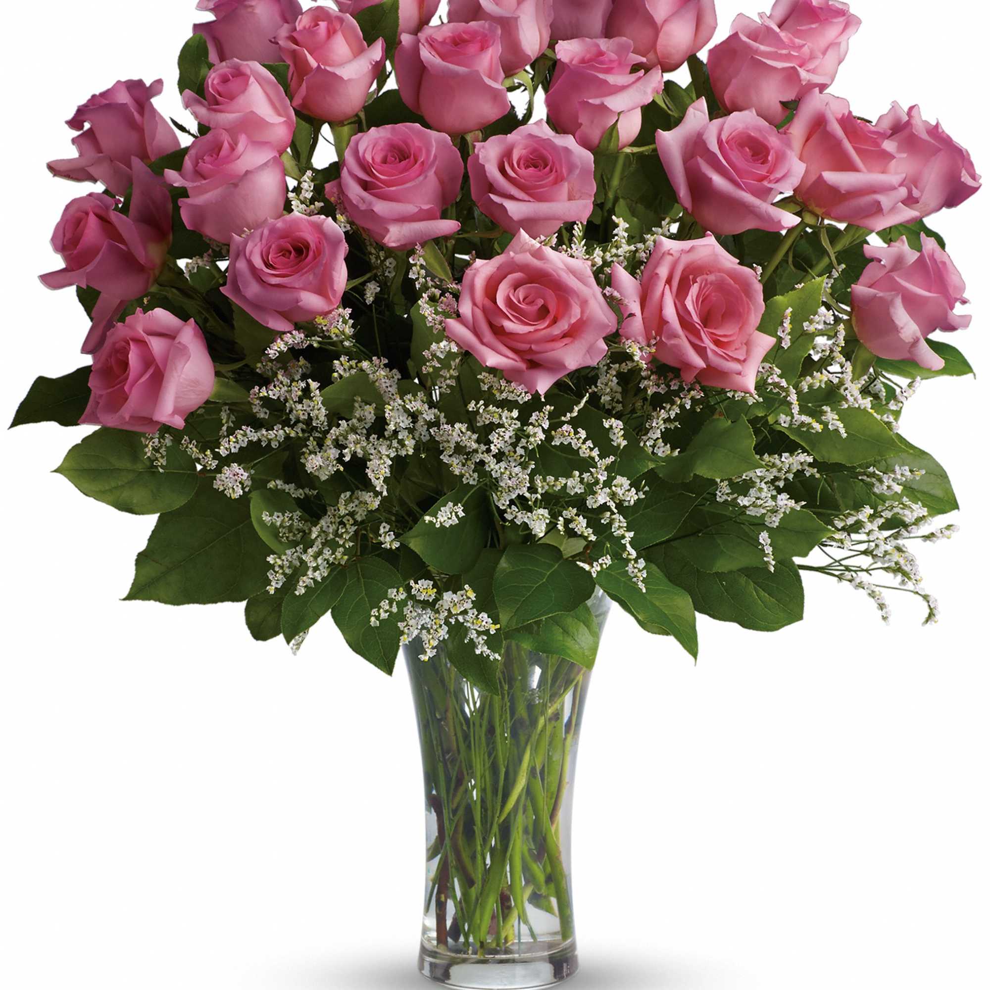 Pink roses arranged in a clear glass vase with white filler flowers