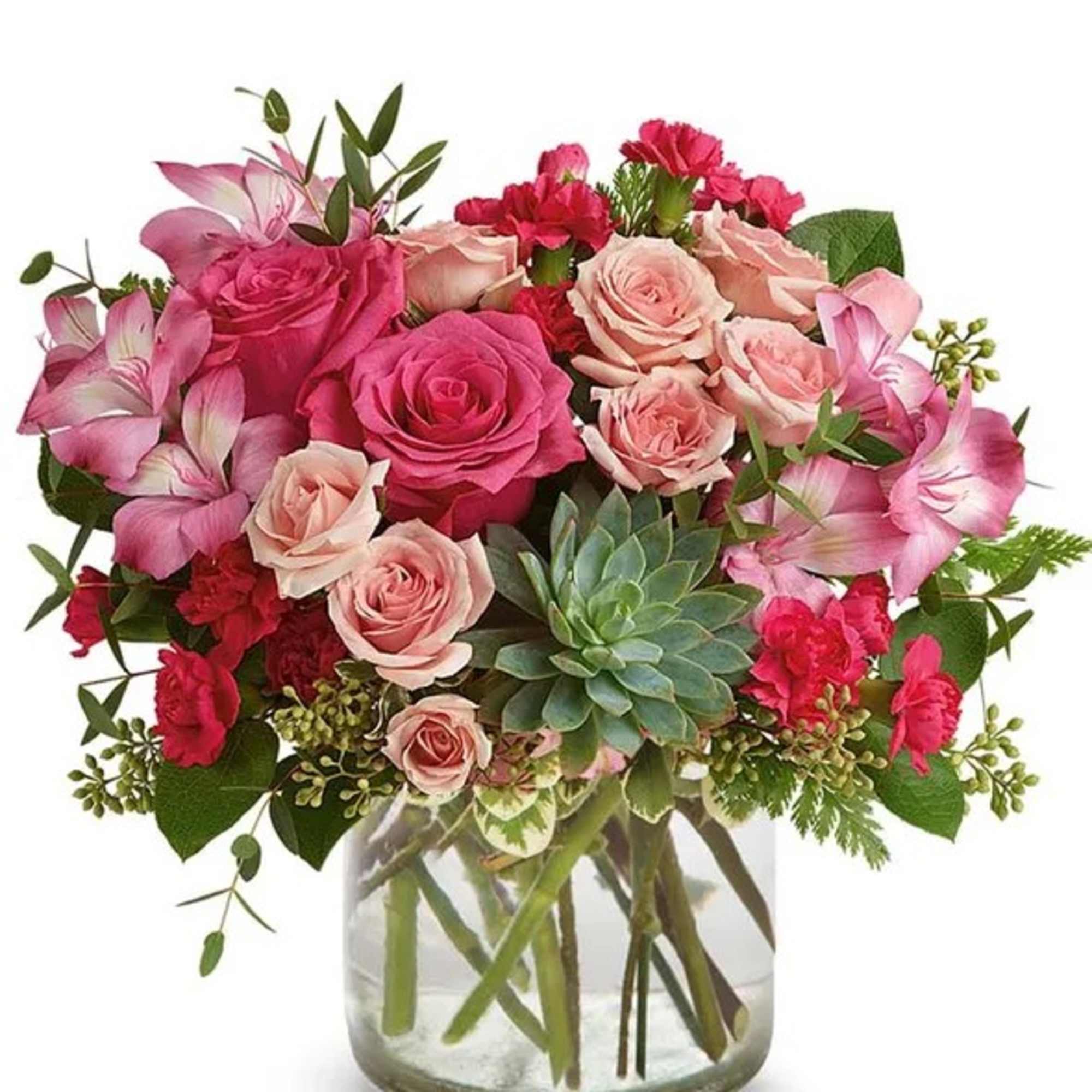 Pink and blush roses in a glass vase with a succulent accent