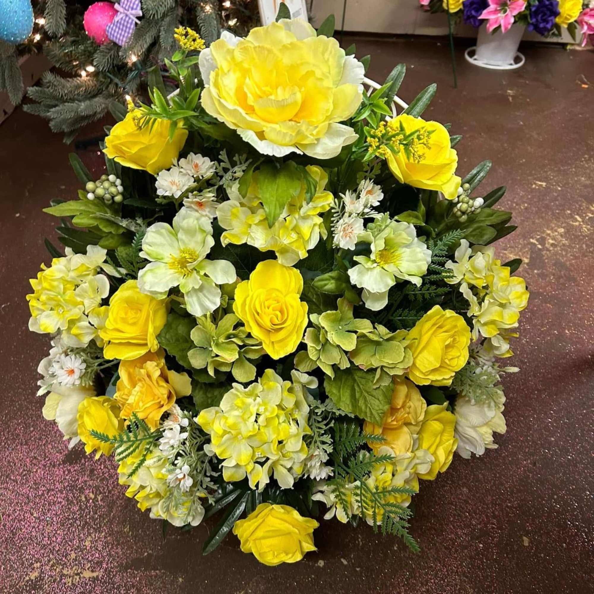 Yellow and white floral arrangement with roses and mixed blooms