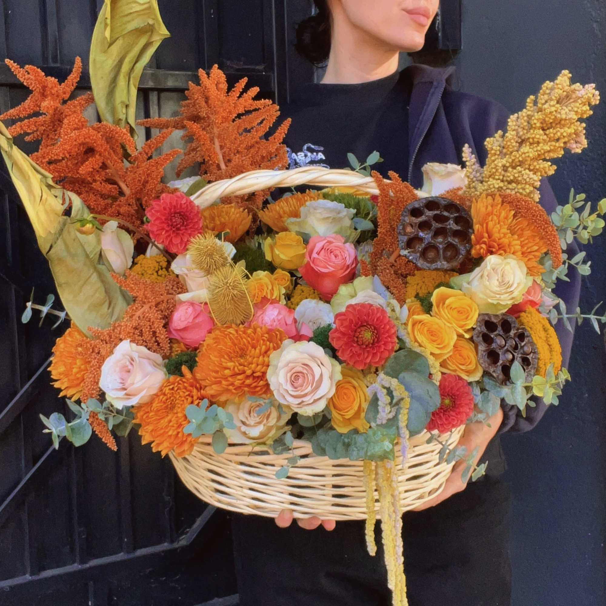 Large basket of orange, yellow, pink, and white flowers
