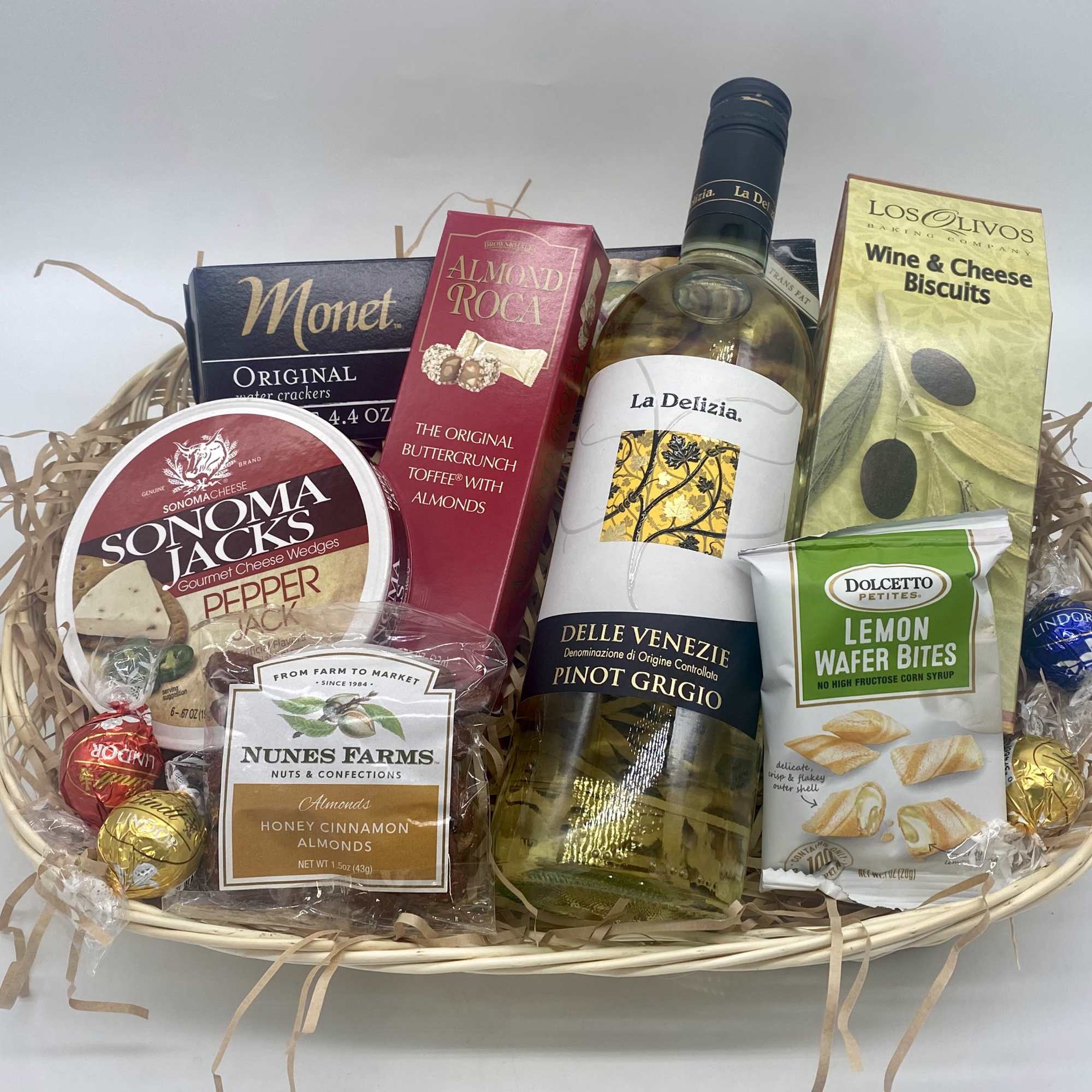 Gift basket with wine, crackers, cheese, nuts, and chocolates