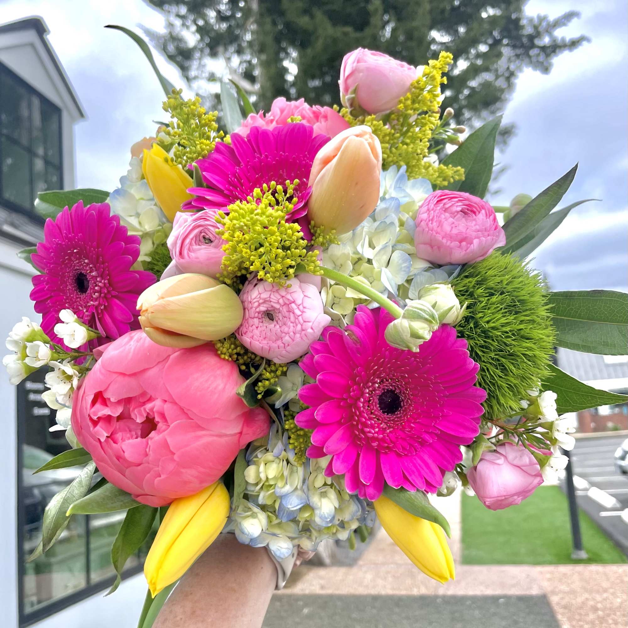 Bright pink bouquet with tulips, gerbera daisies, peonies, and hydrangeas