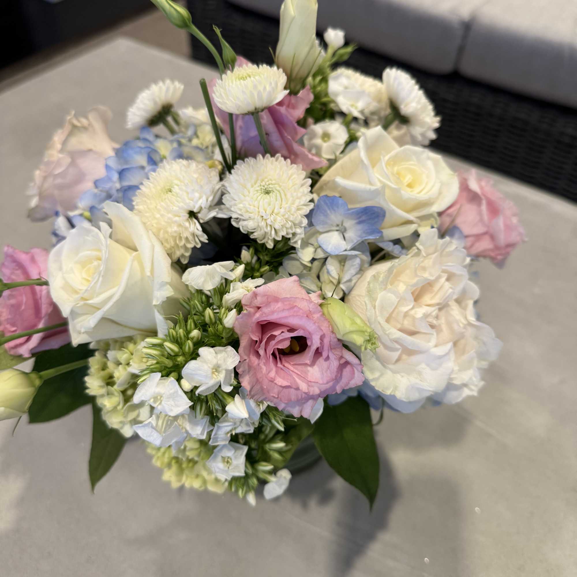Bouquet of white and pink roses with blue hydrangea and white mums