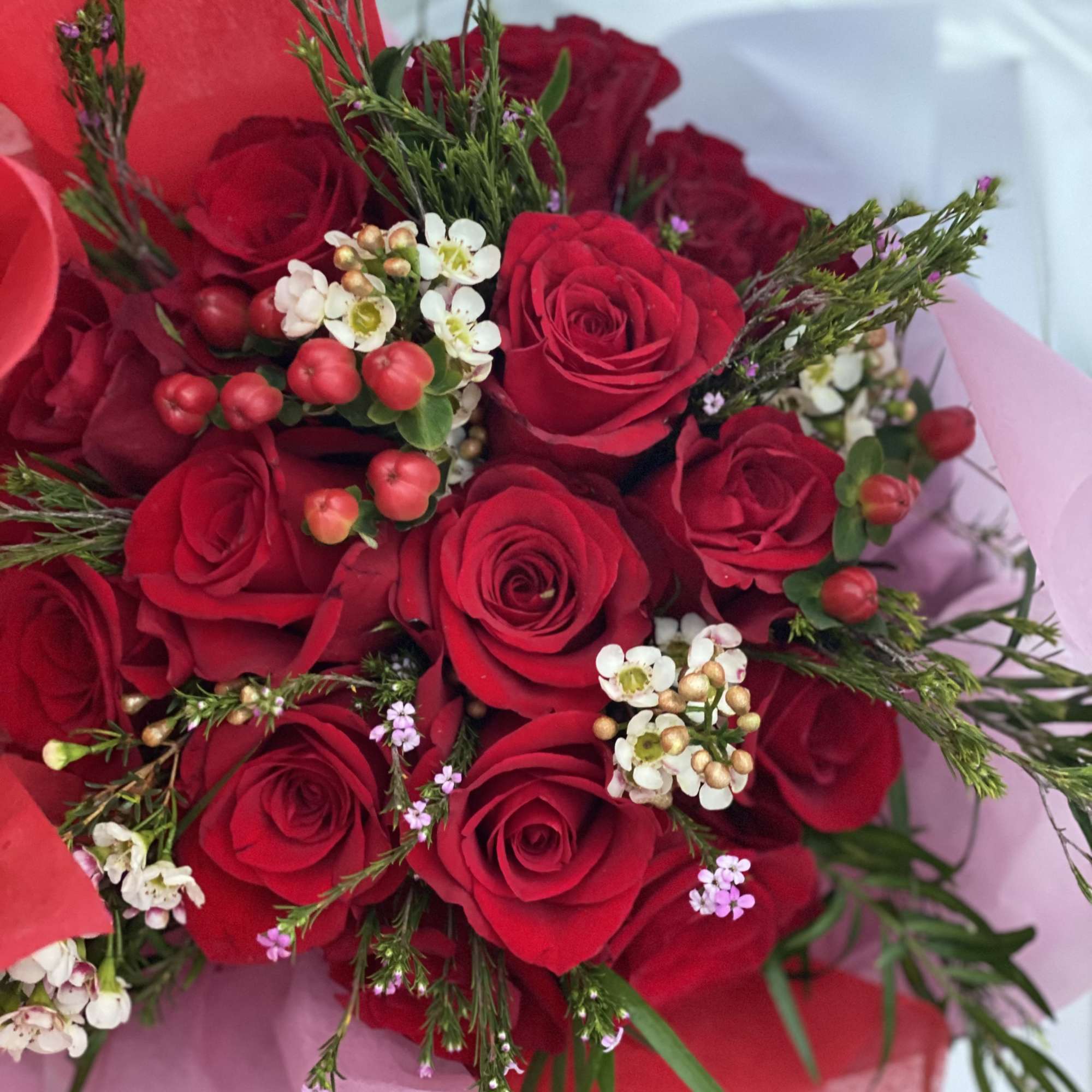 Bouquet of red roses with small white filler flowers