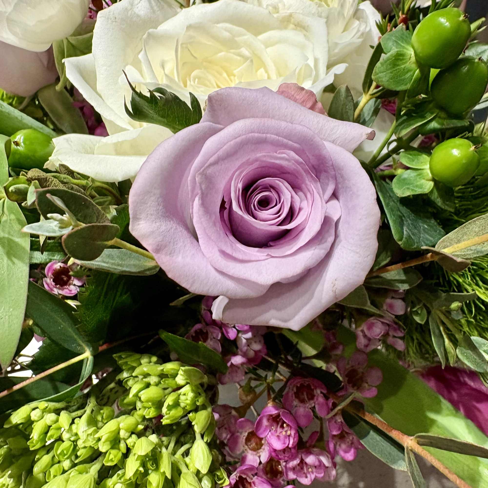 Bouquet of lavender and white roses with green filler flowers