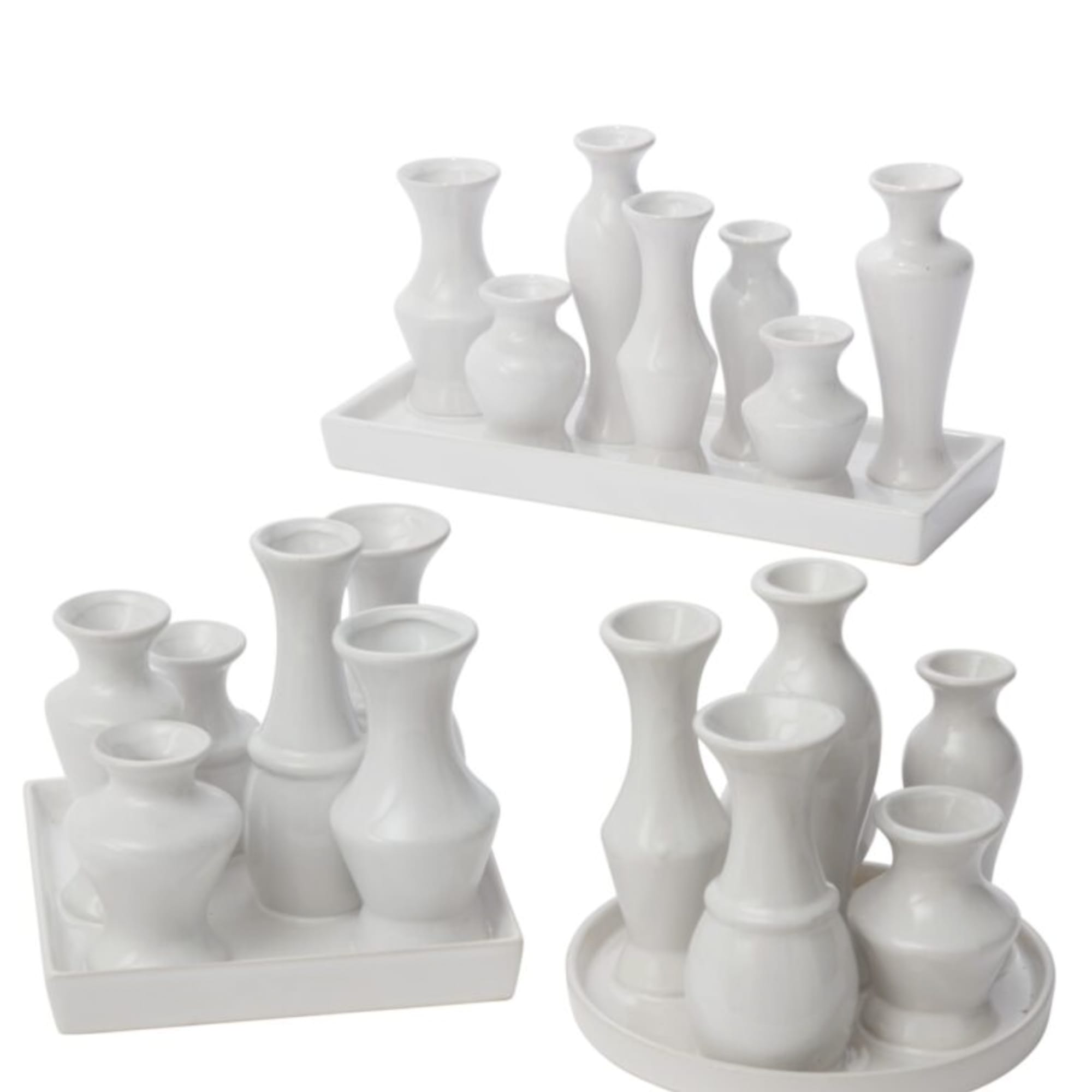 Set of white ceramic bud vases on trays