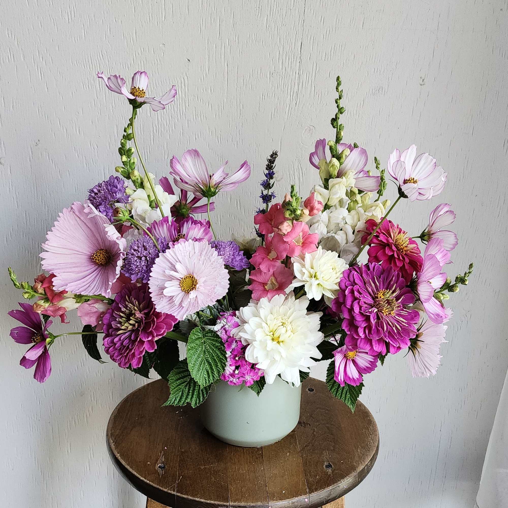 Pink and purple mixed bouquet in a pale vase