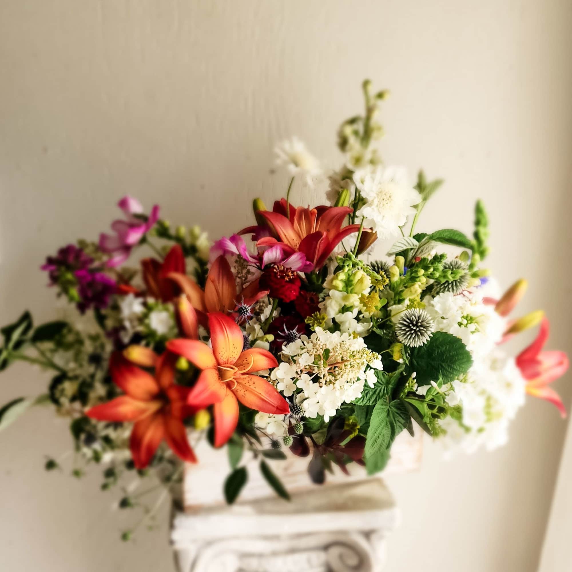 Mixed bouquet of orange lilies, white blooms, and pink flowers
