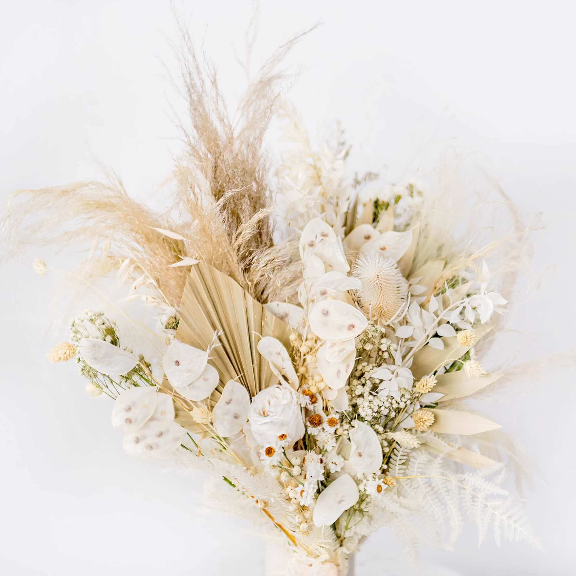 Cream and beige dried bouquet with feathery grasses and white petals