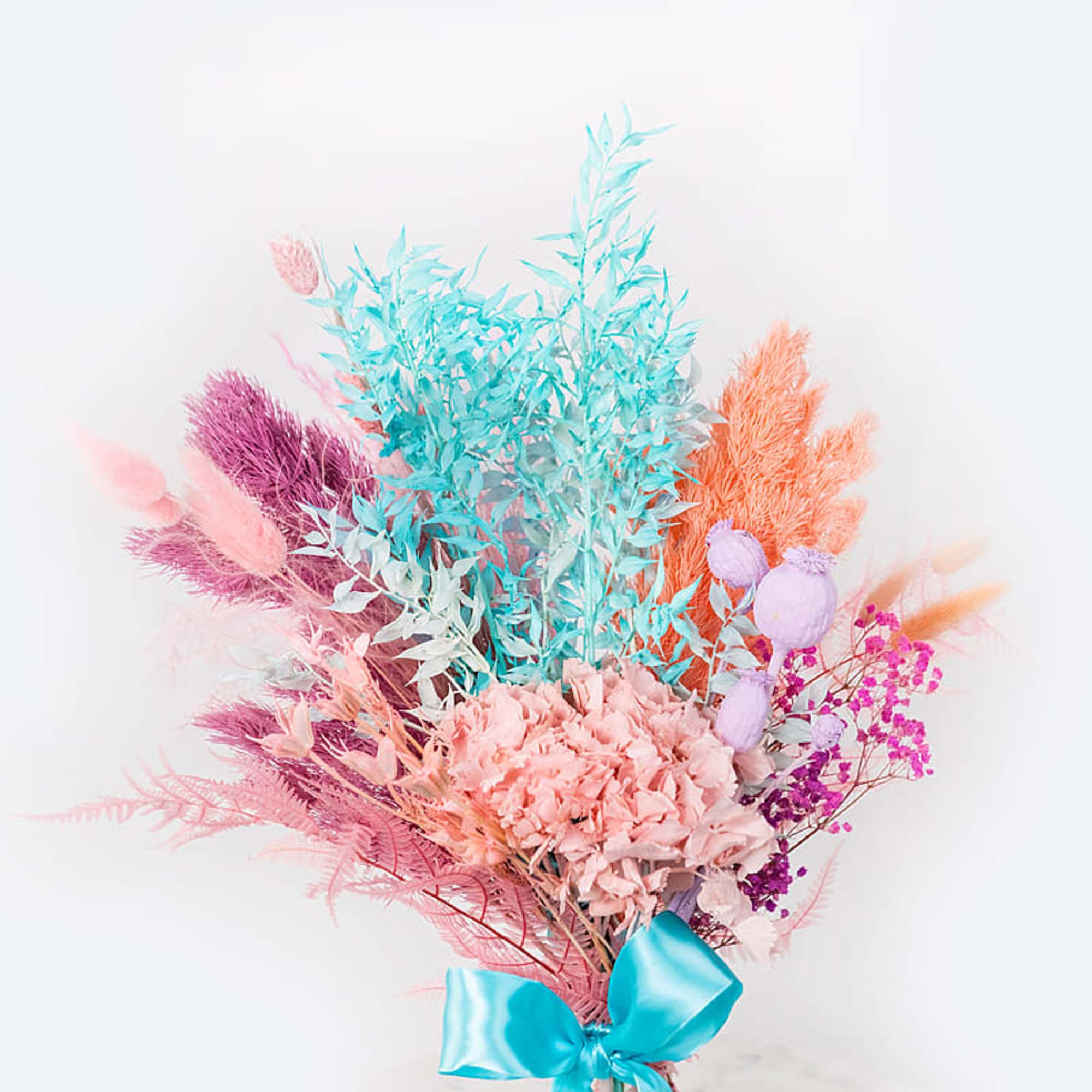 Pastel bouquet with pink, blue, and purple dried flowers tied with a blue ribbon