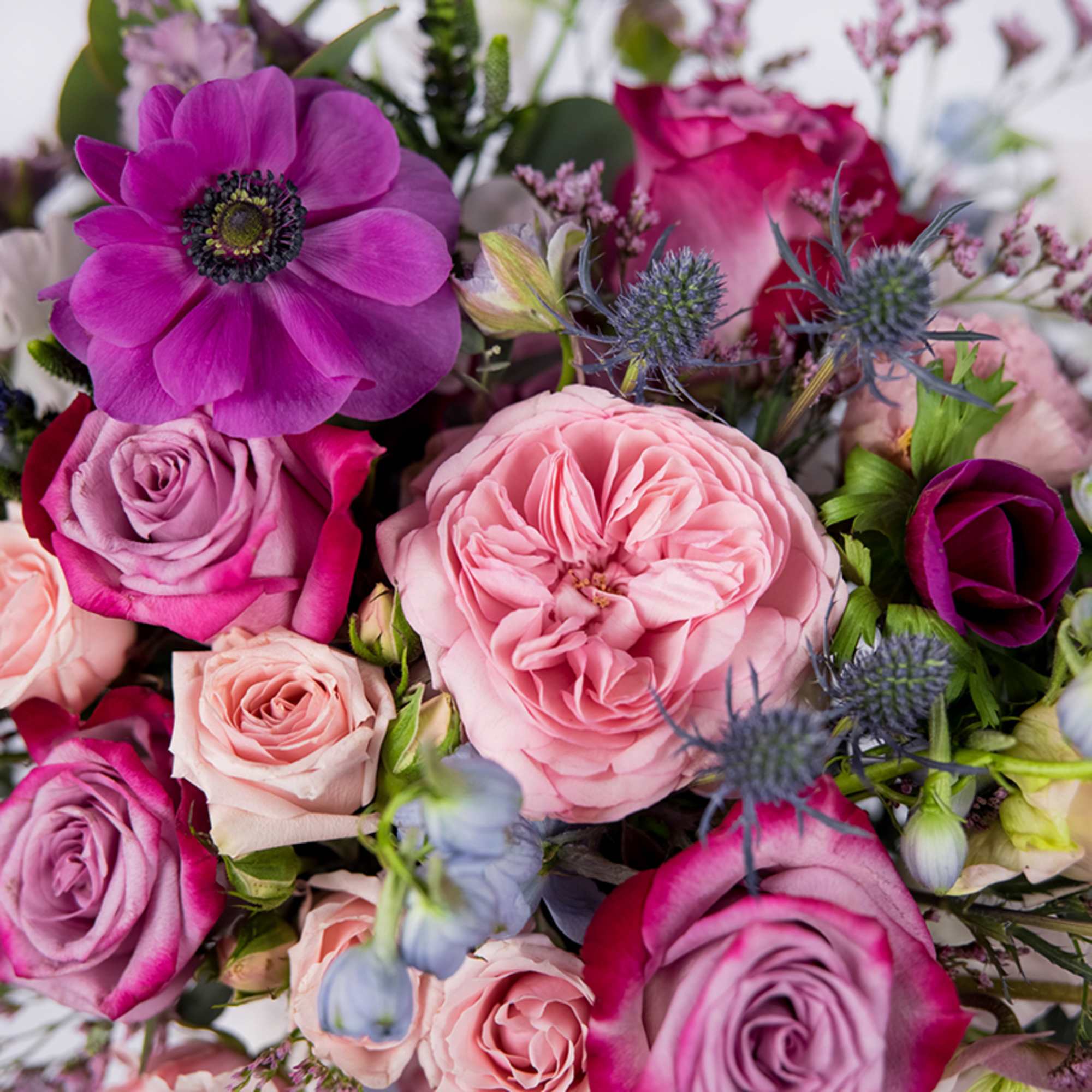 Bouquet of pink and purple roses with a large pink bloom