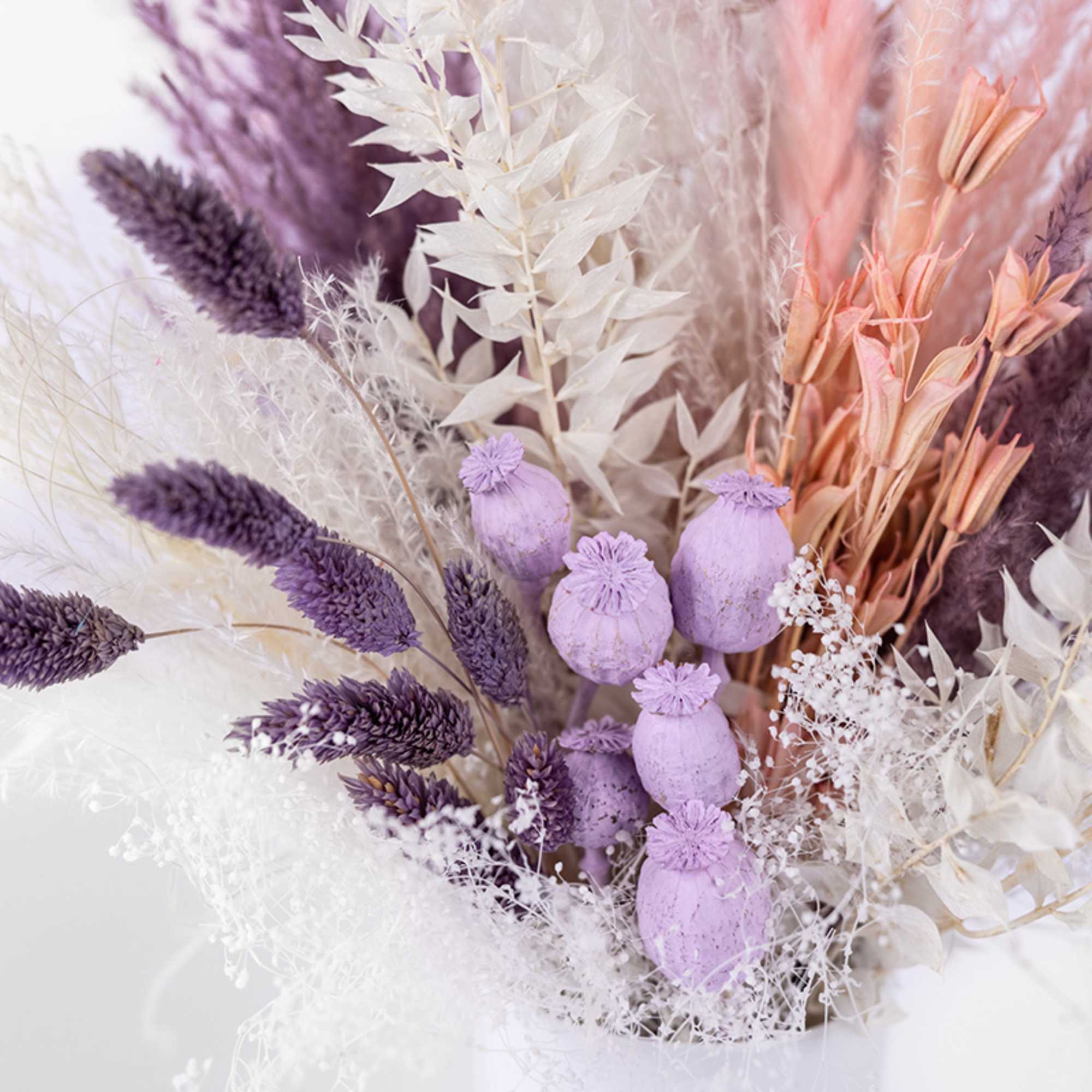 Dried bouquet with purple, white, and peach-toned stems