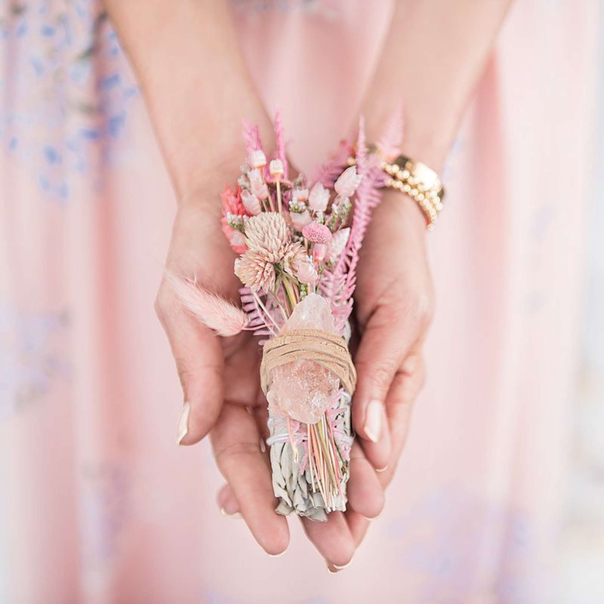 Small pink dried flower bundle held in hands
