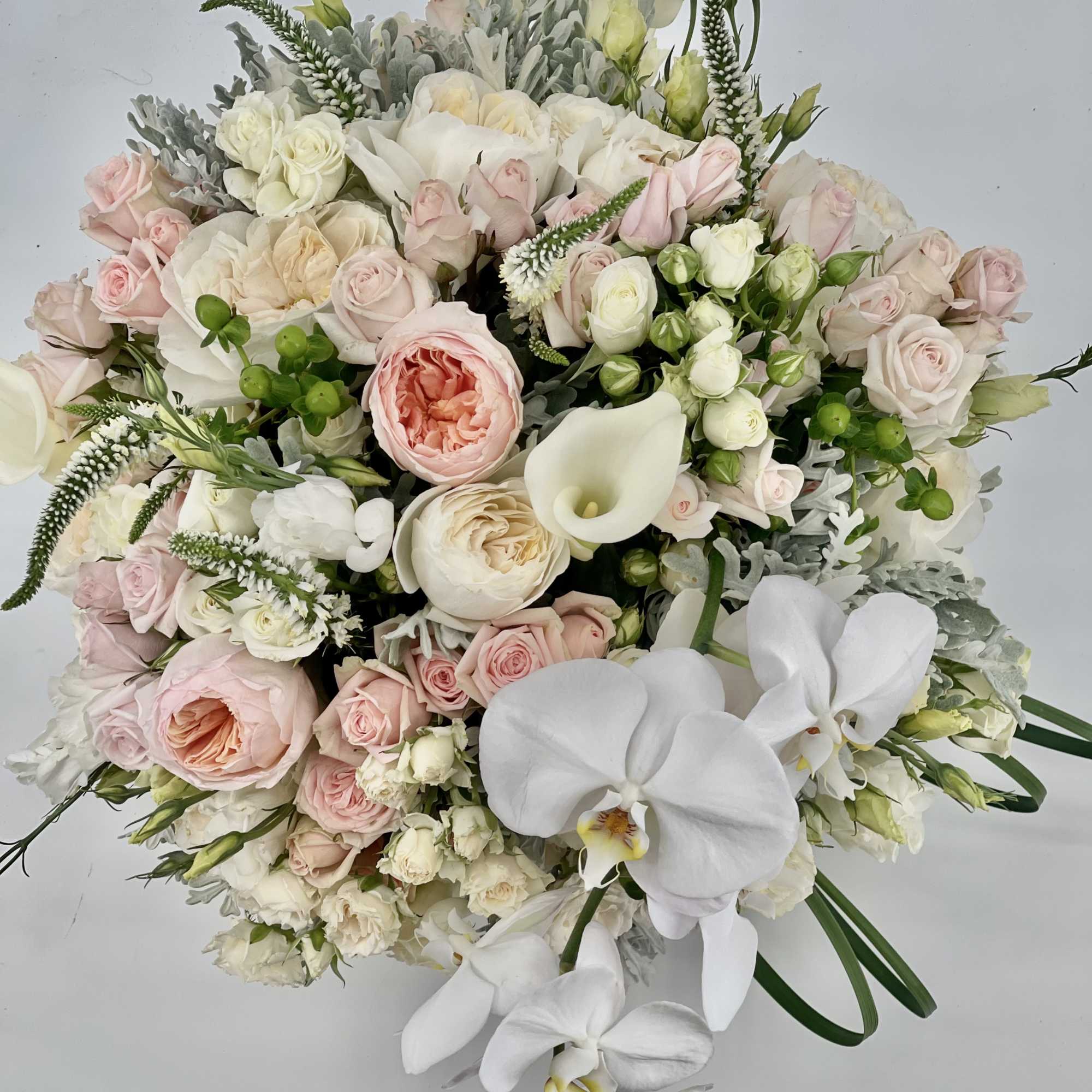 Large bouquet of pale pink and white roses with white orchids