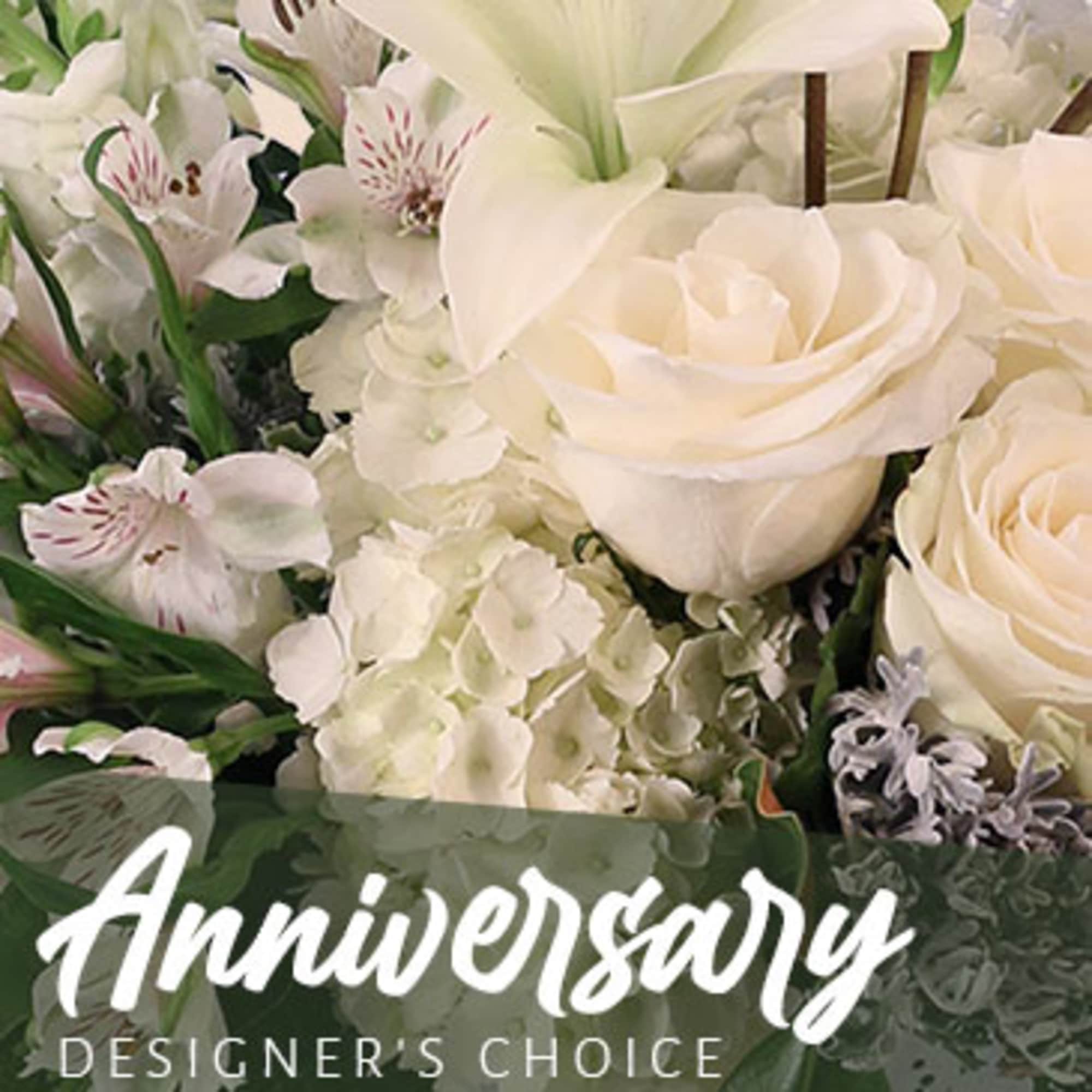 White roses and lilies with hydrangeas in a floral arrangement