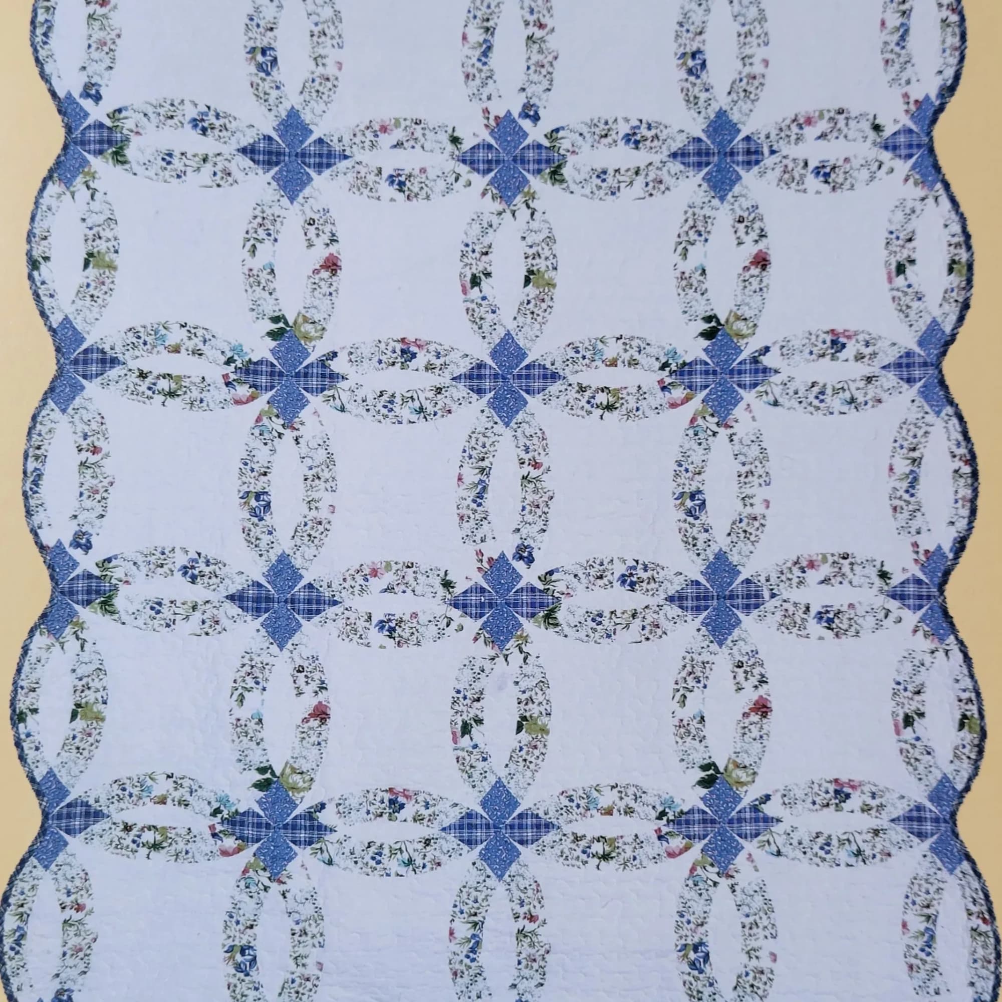 Blue and white quilt with floral ring patterns