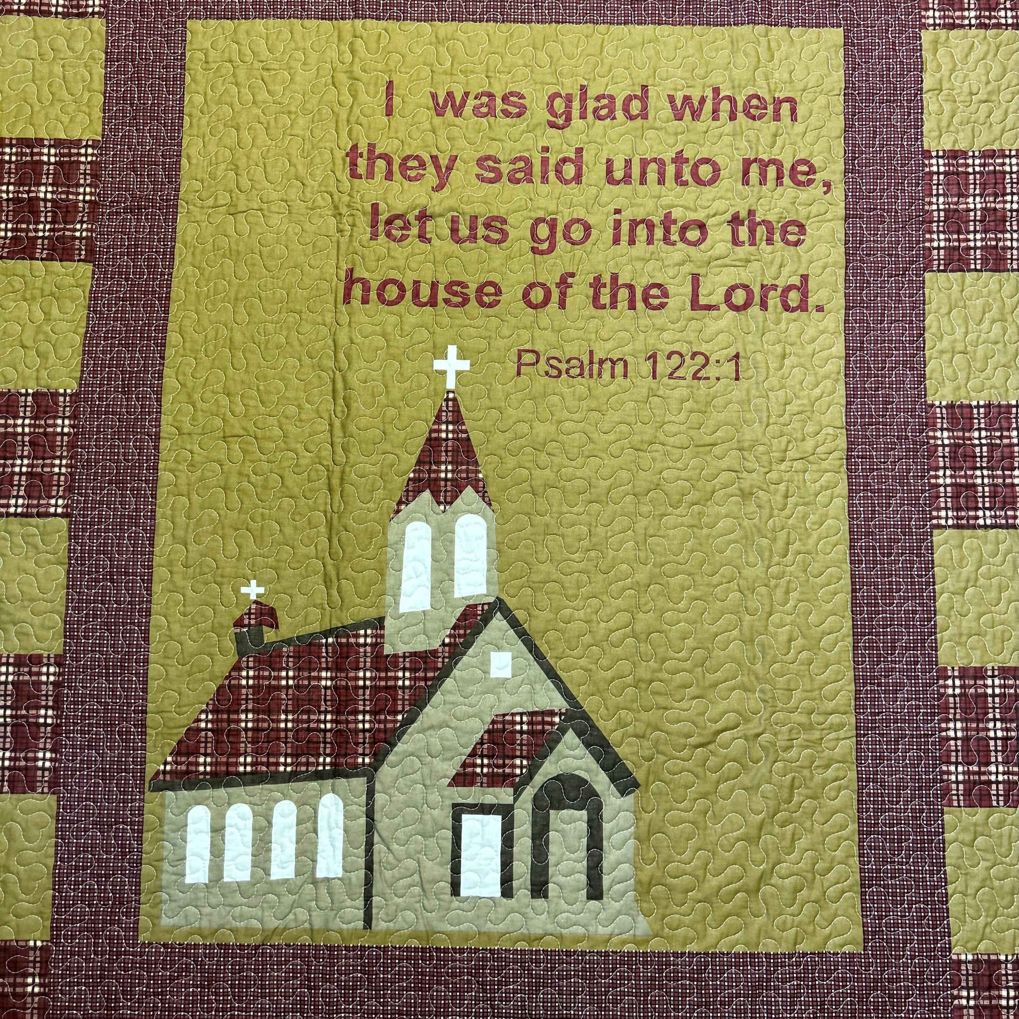 Quilted wall hanging with a church and Psalm 122:1 text