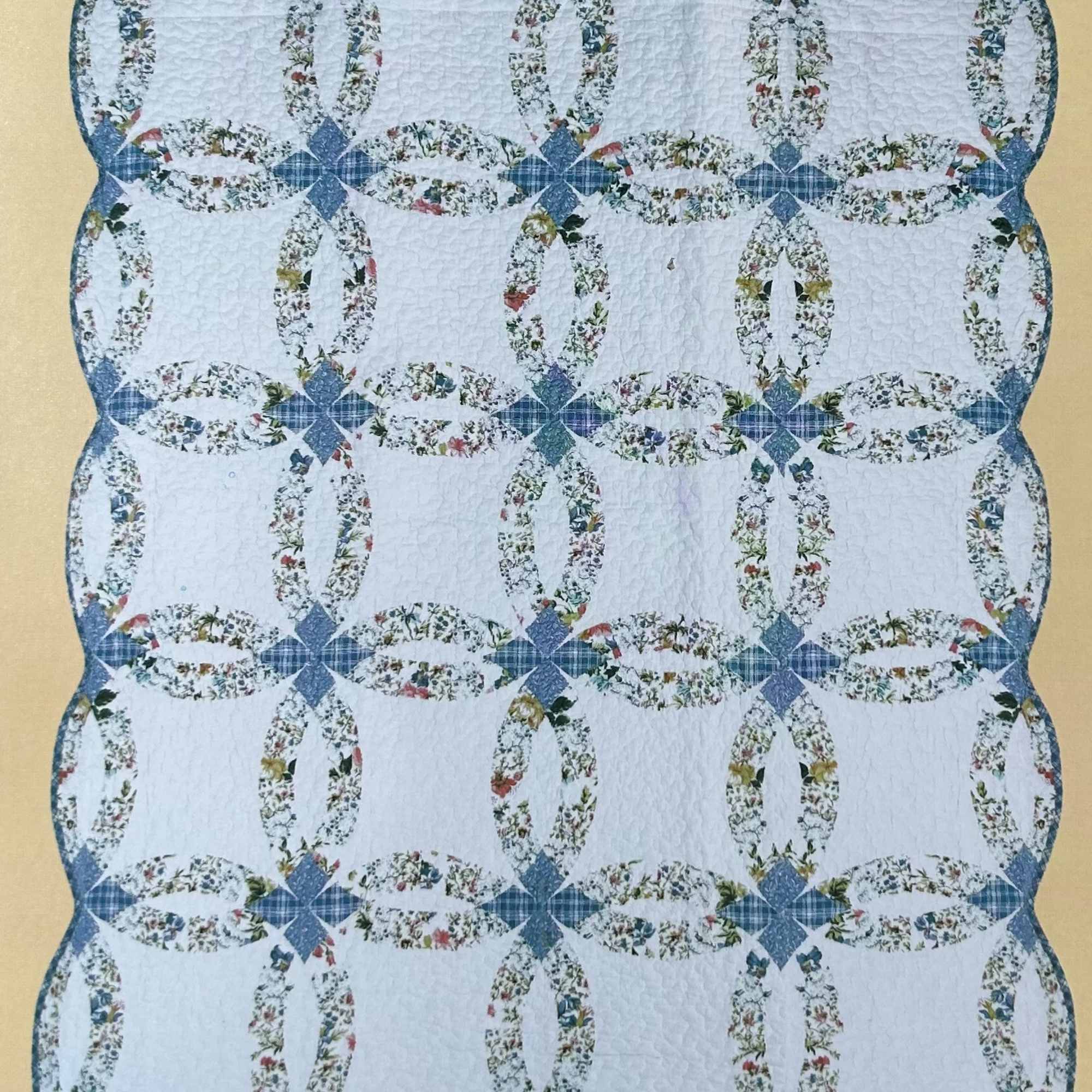 Blue and white quilt with floral oval ring patterns
