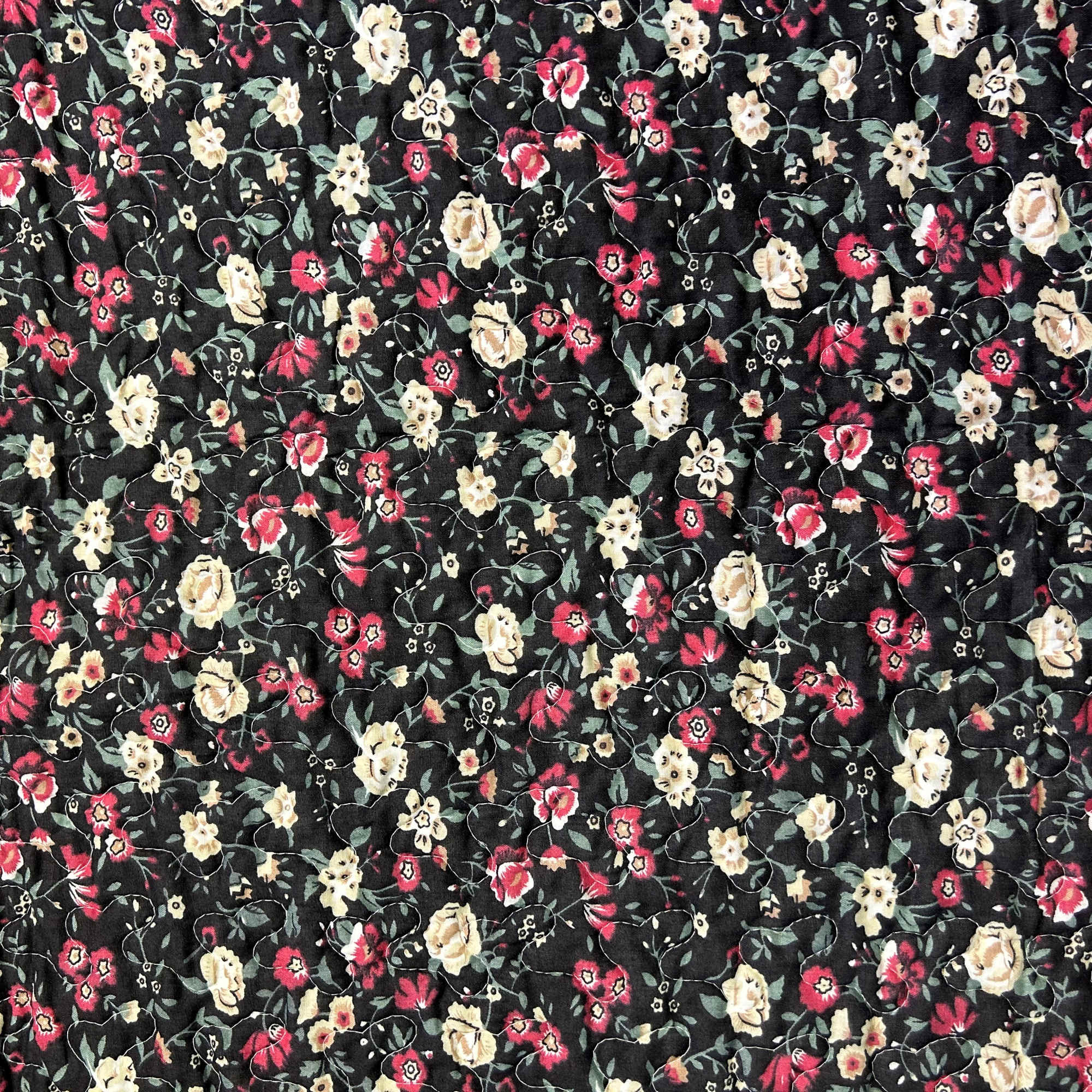 Black floral quilted fabric with small pink and cream flowers