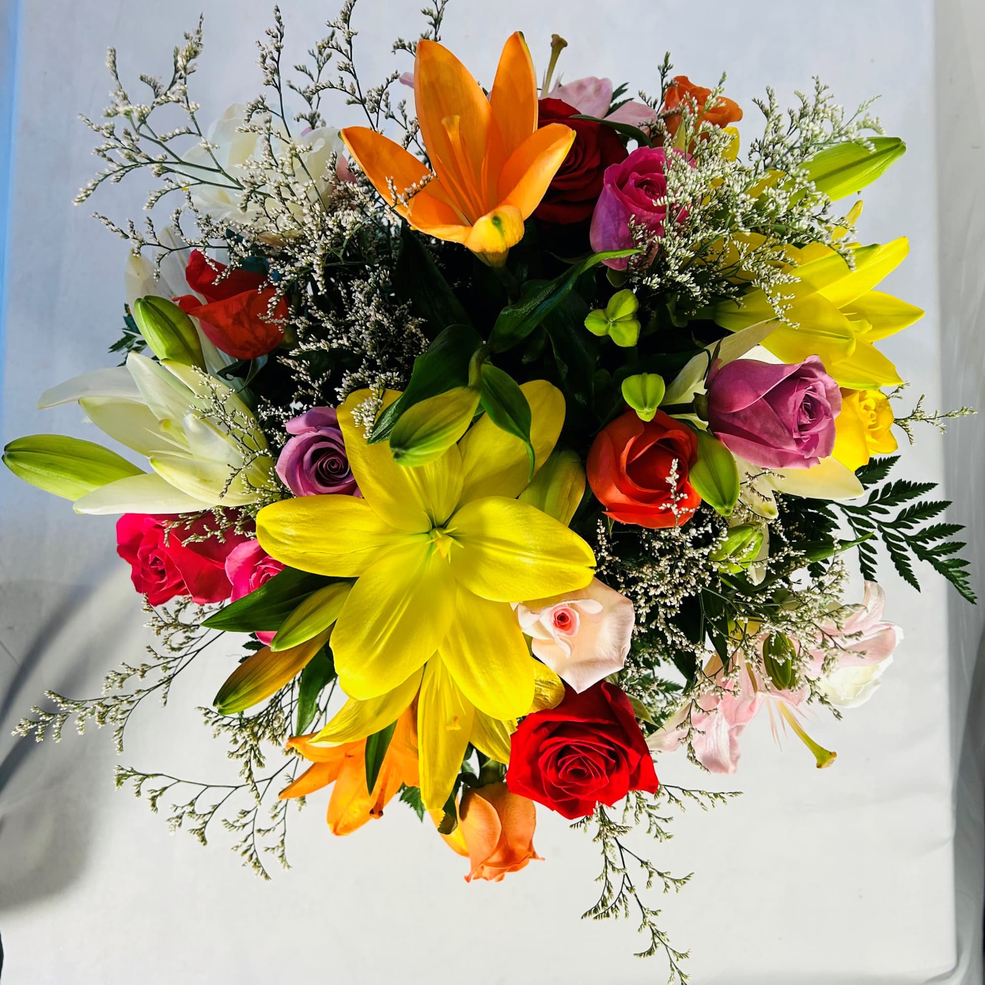 Sunlit yellow and orange lilies mingle with red, pink, orange and lavender, photo 2 of 2