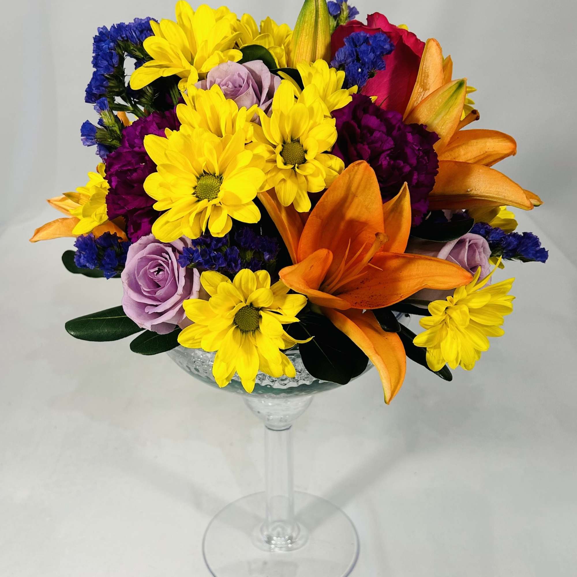 Colorful bouquet in a clear stemmed glass vase