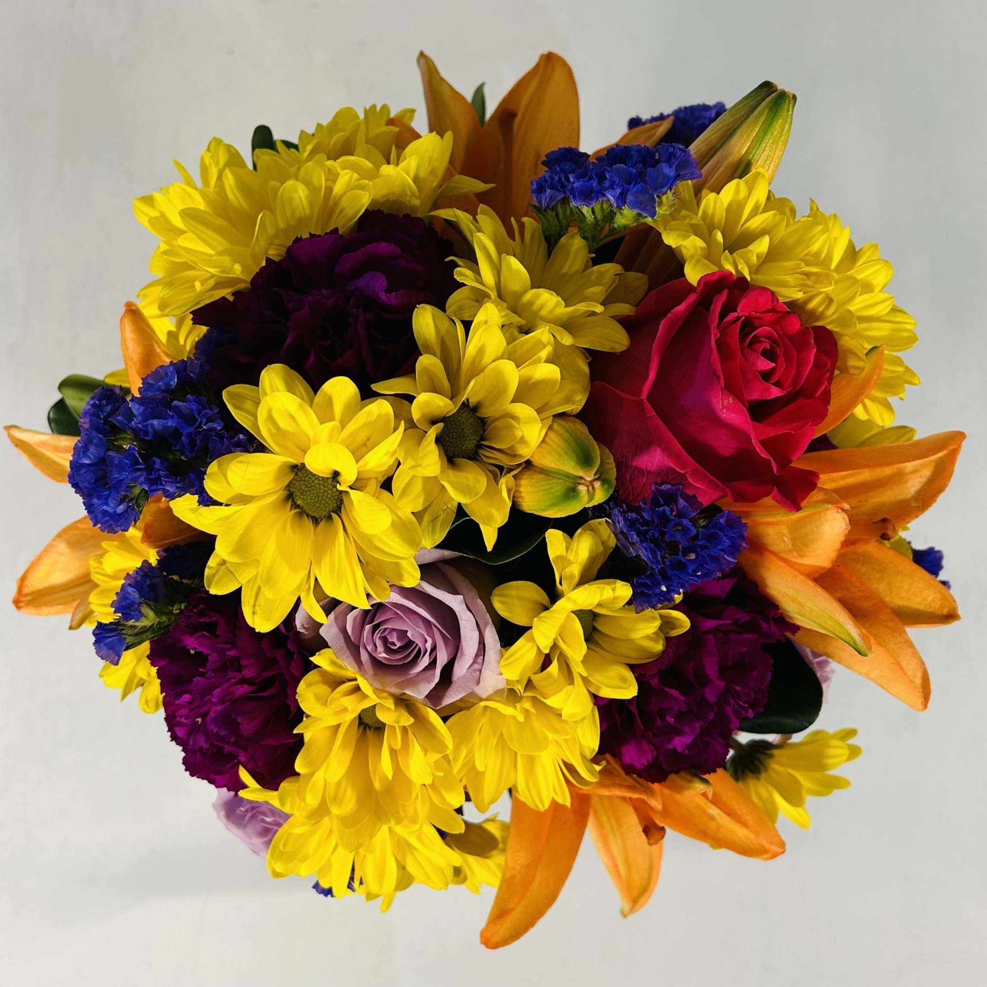 Colorful bouquet with yellow daisies, roses, and orange lilies