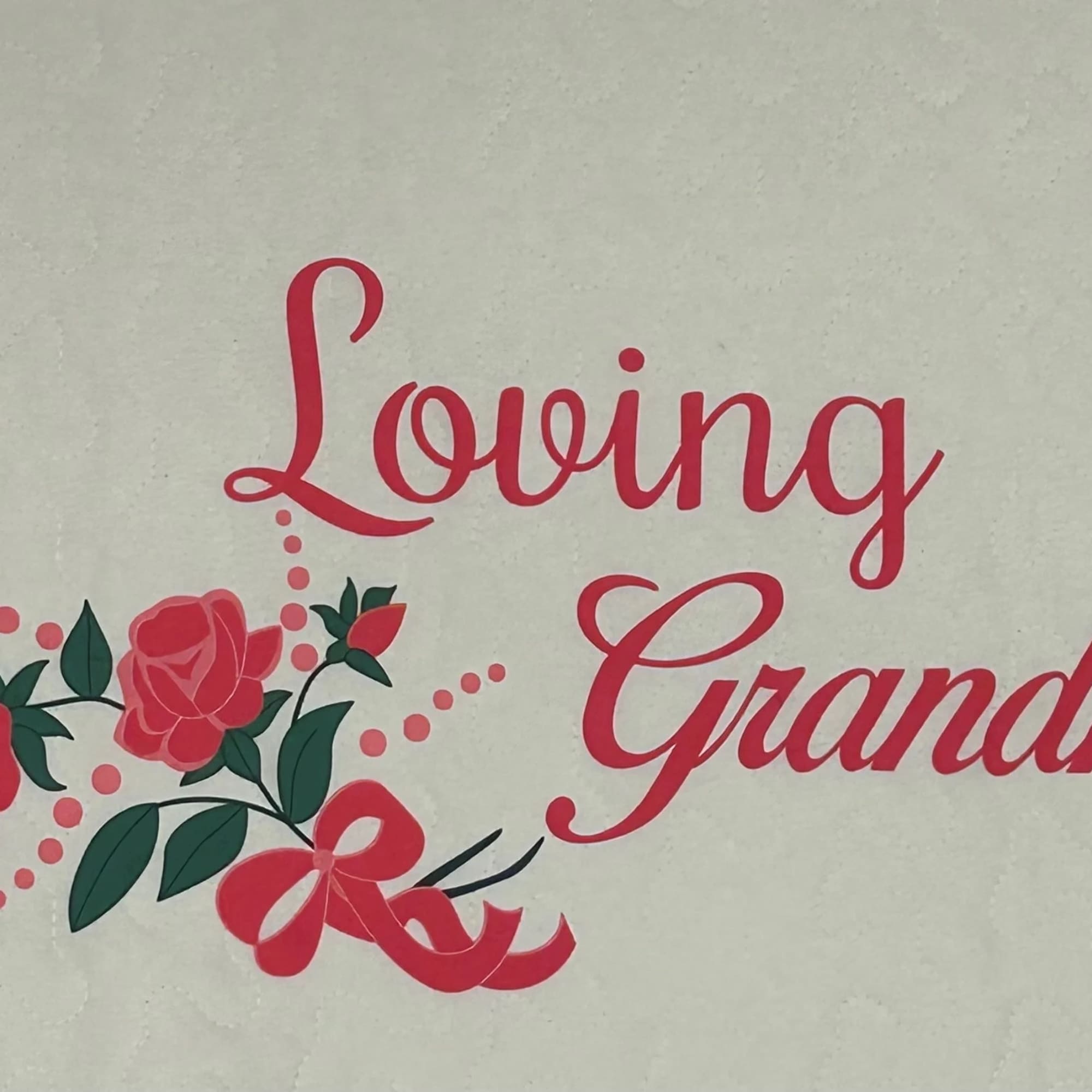 Pink "Loving Grandma" text with rose graphics on a quilted white background.