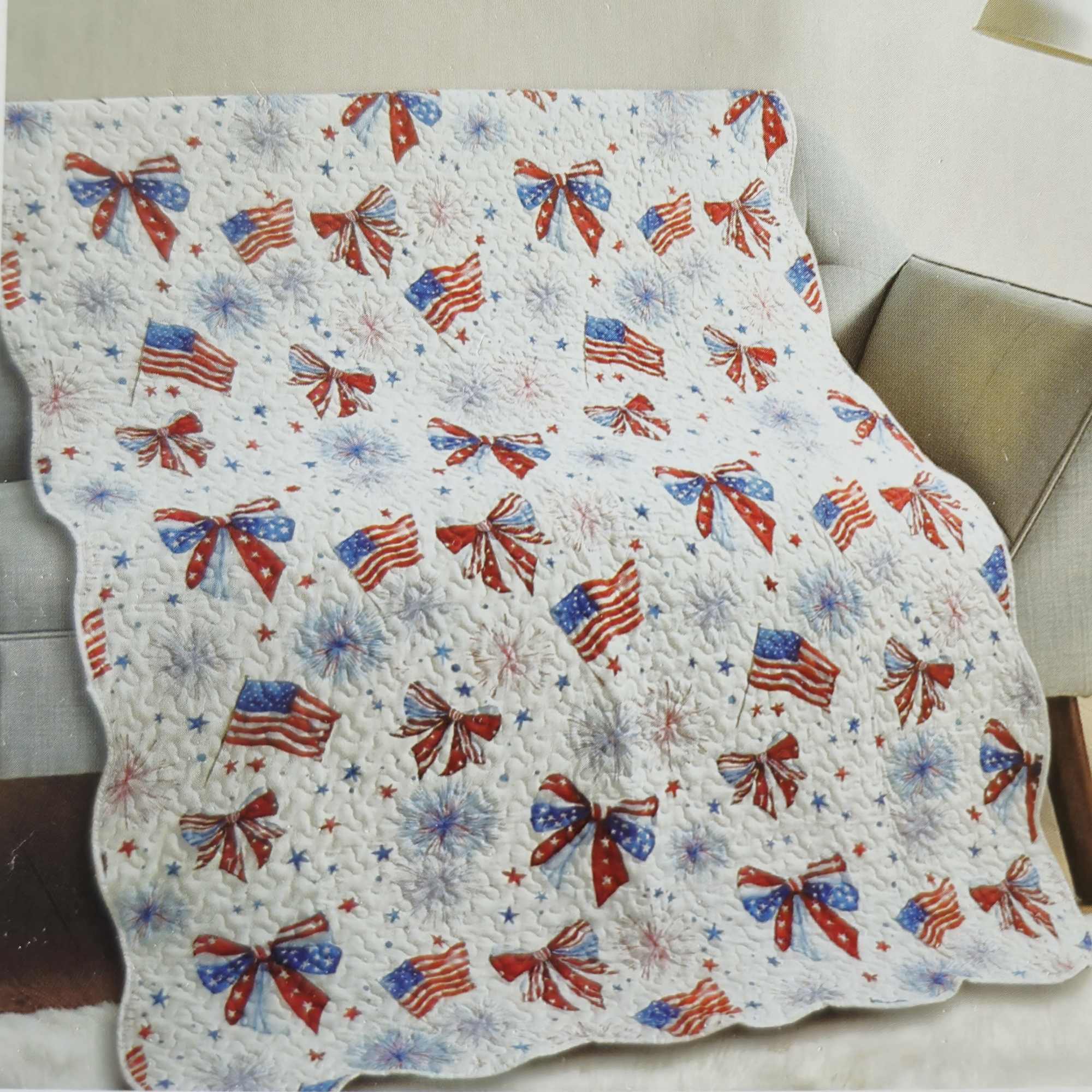 A cheerful quilted throw patterned with red, white and blue bows, flags