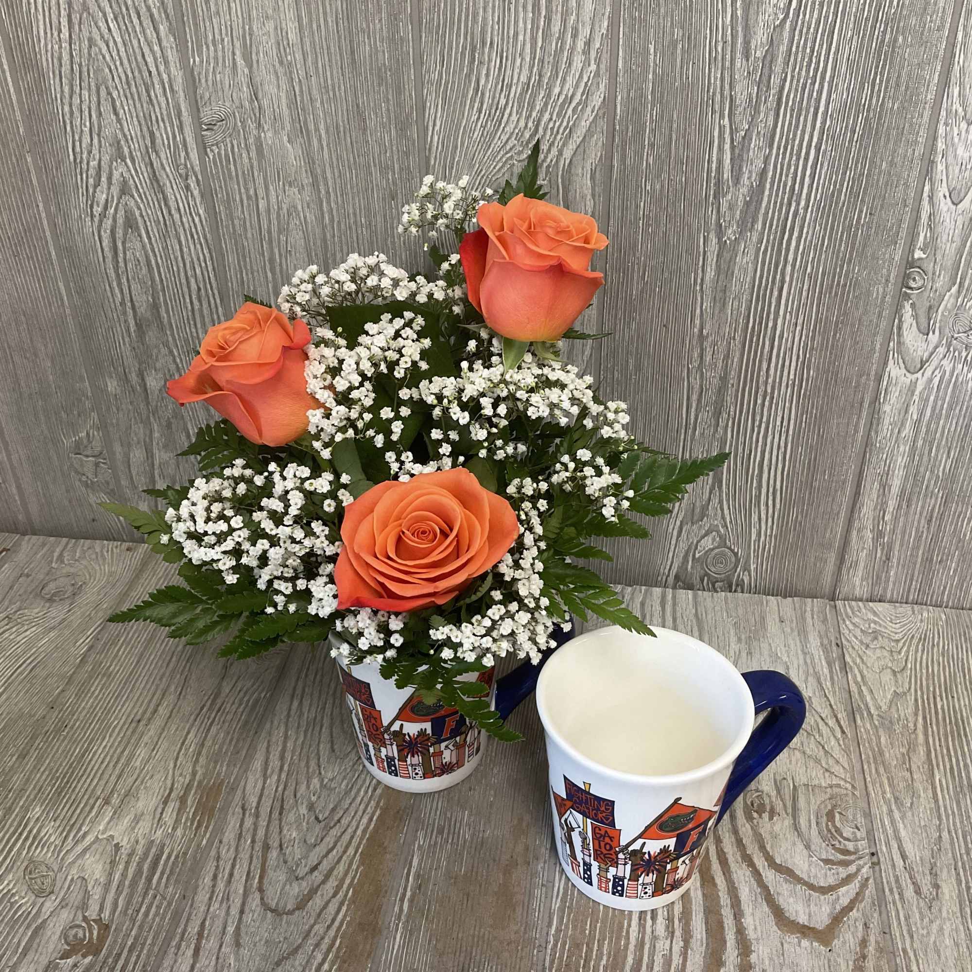 Orange roses arranged in a keepsake ceramic Gator mug!