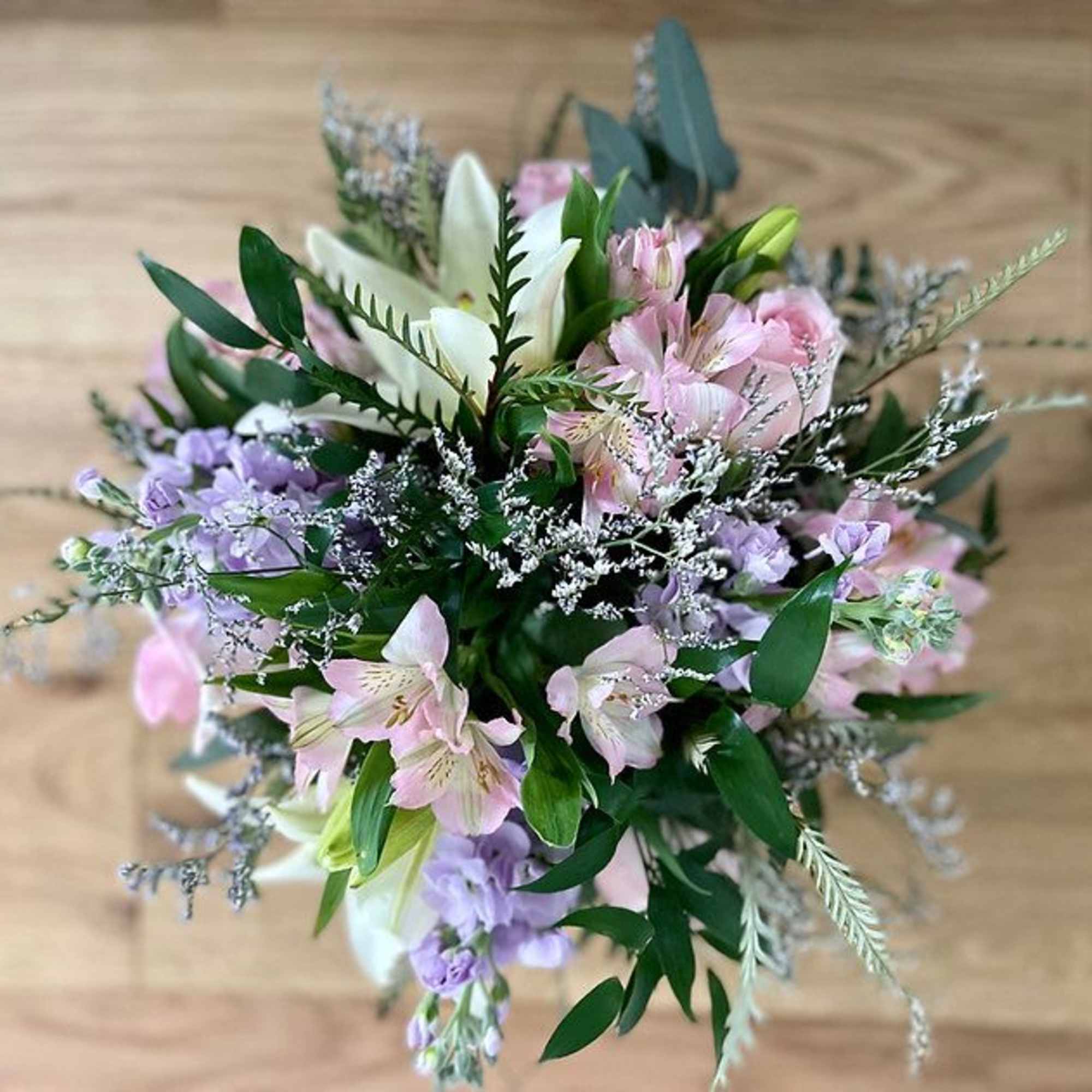 Bouquet of pink, white, and lavender flowers with greenery