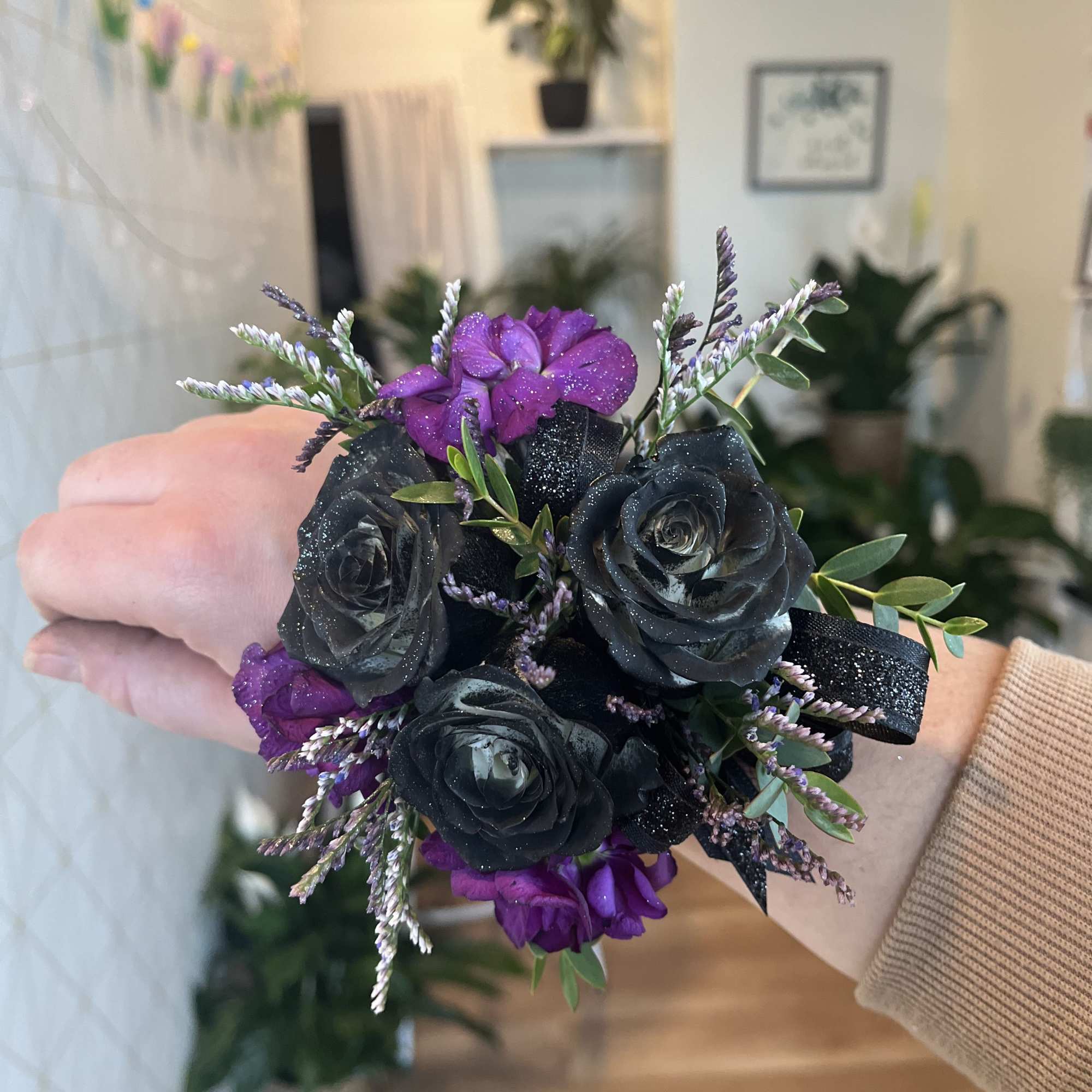 Small wrist corsage with black and purple roses