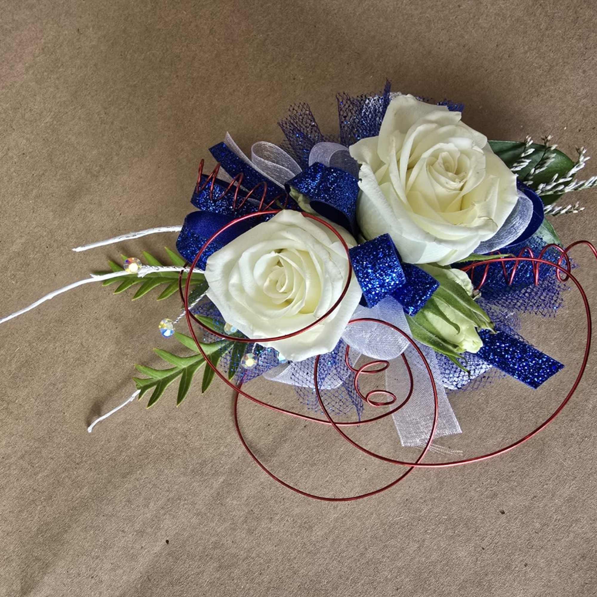 Two white roses with blue ribbon and red wire accents