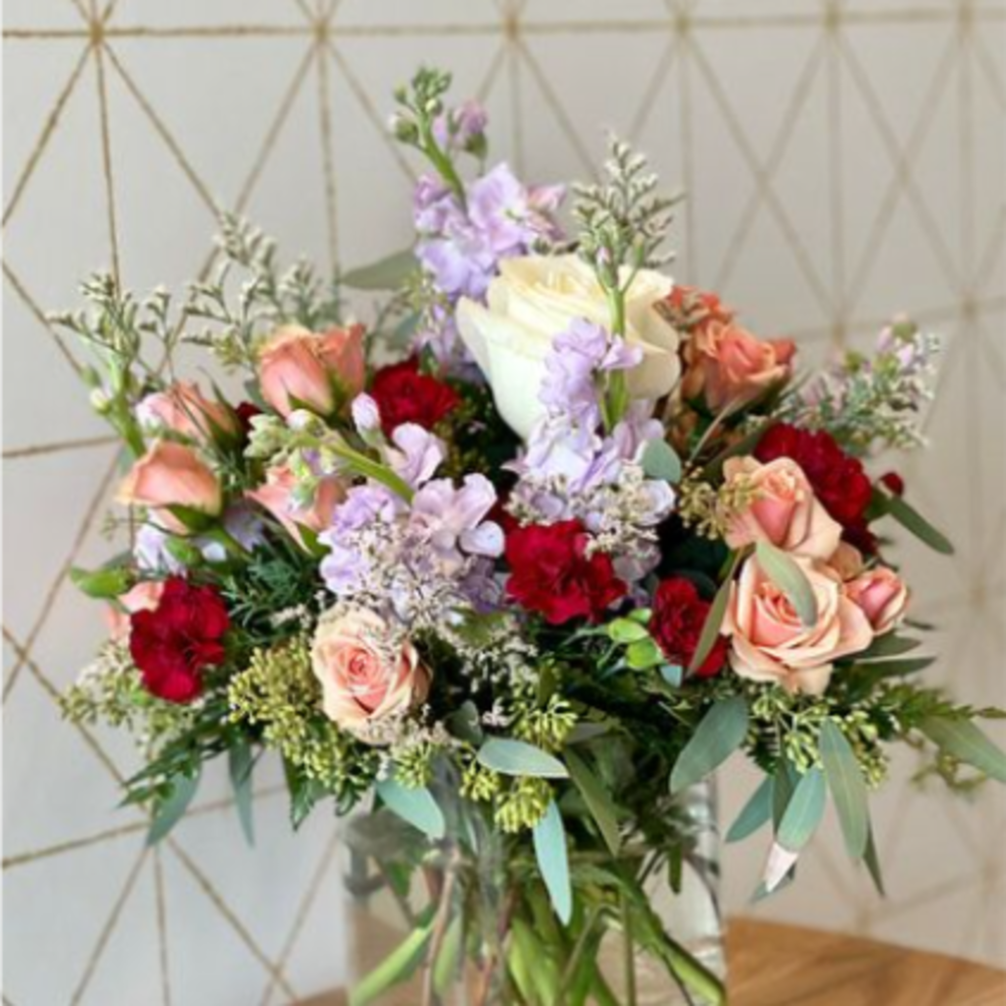 A lush mix of blooms and fresh greenery, artfully arranged to capture