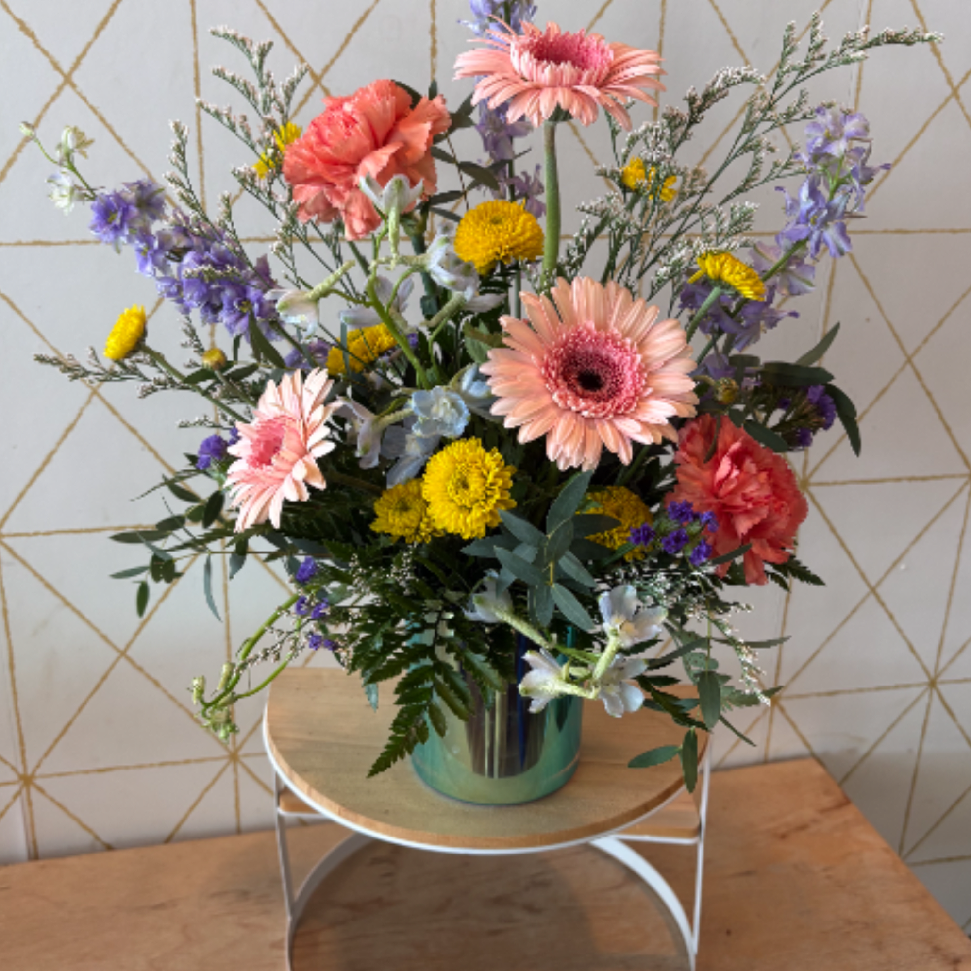 Playful, polished and full of personality, The Kourtney features blush gerbera daisies